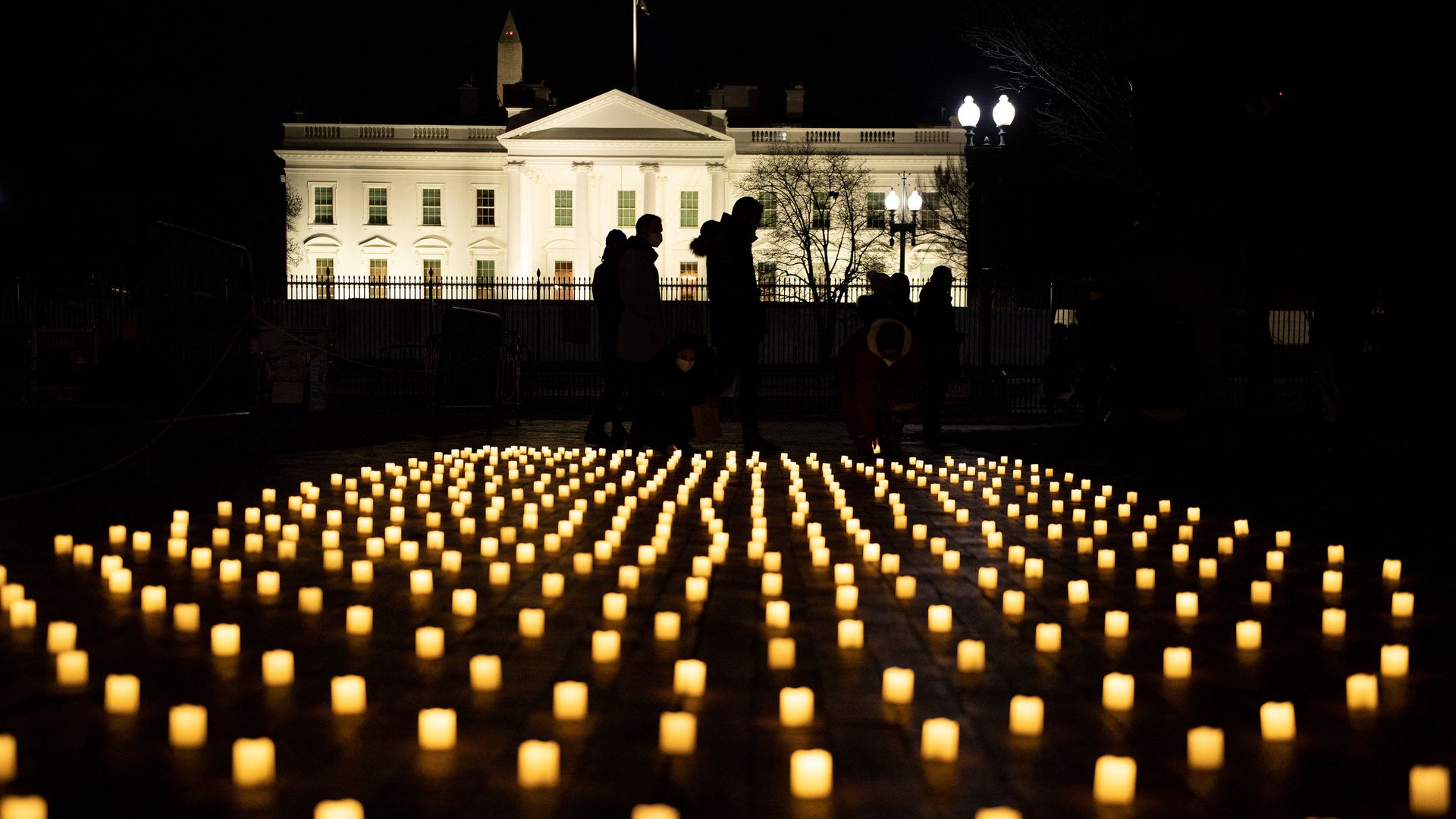 Picture of candles taken at night with the White House in the background
