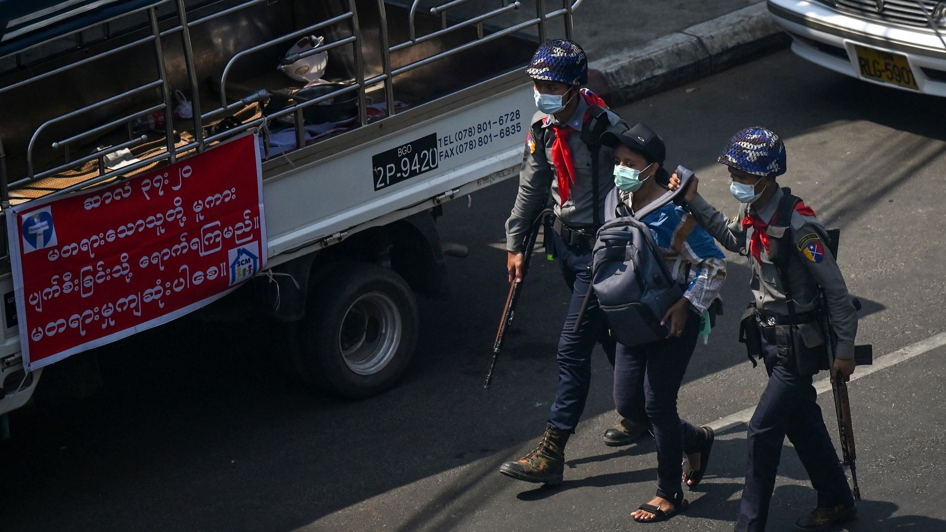 Police arrest Myanmar Now journalist Kay Zon Nwe in Yangon on February 27, 2021, as protesters were taking part in a demonstration against the military coup. 