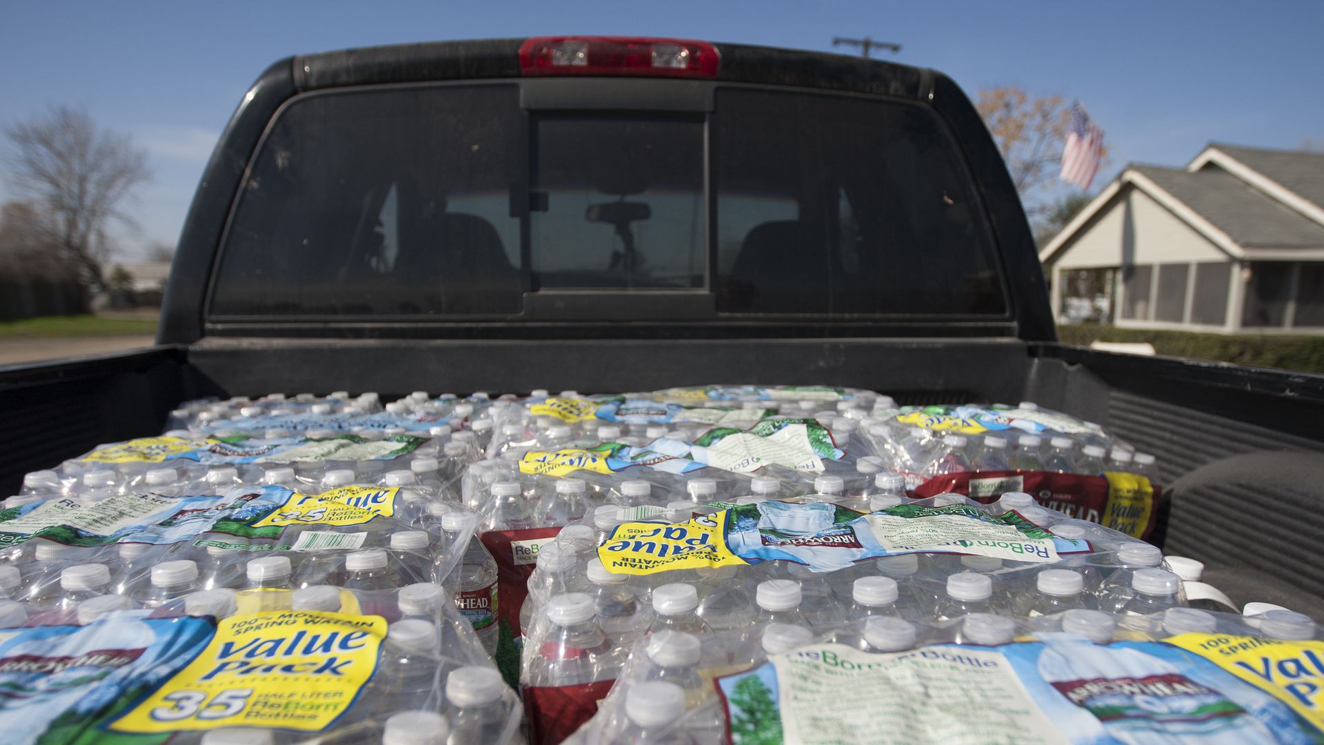 Cases of bottled water in a truck bed. 