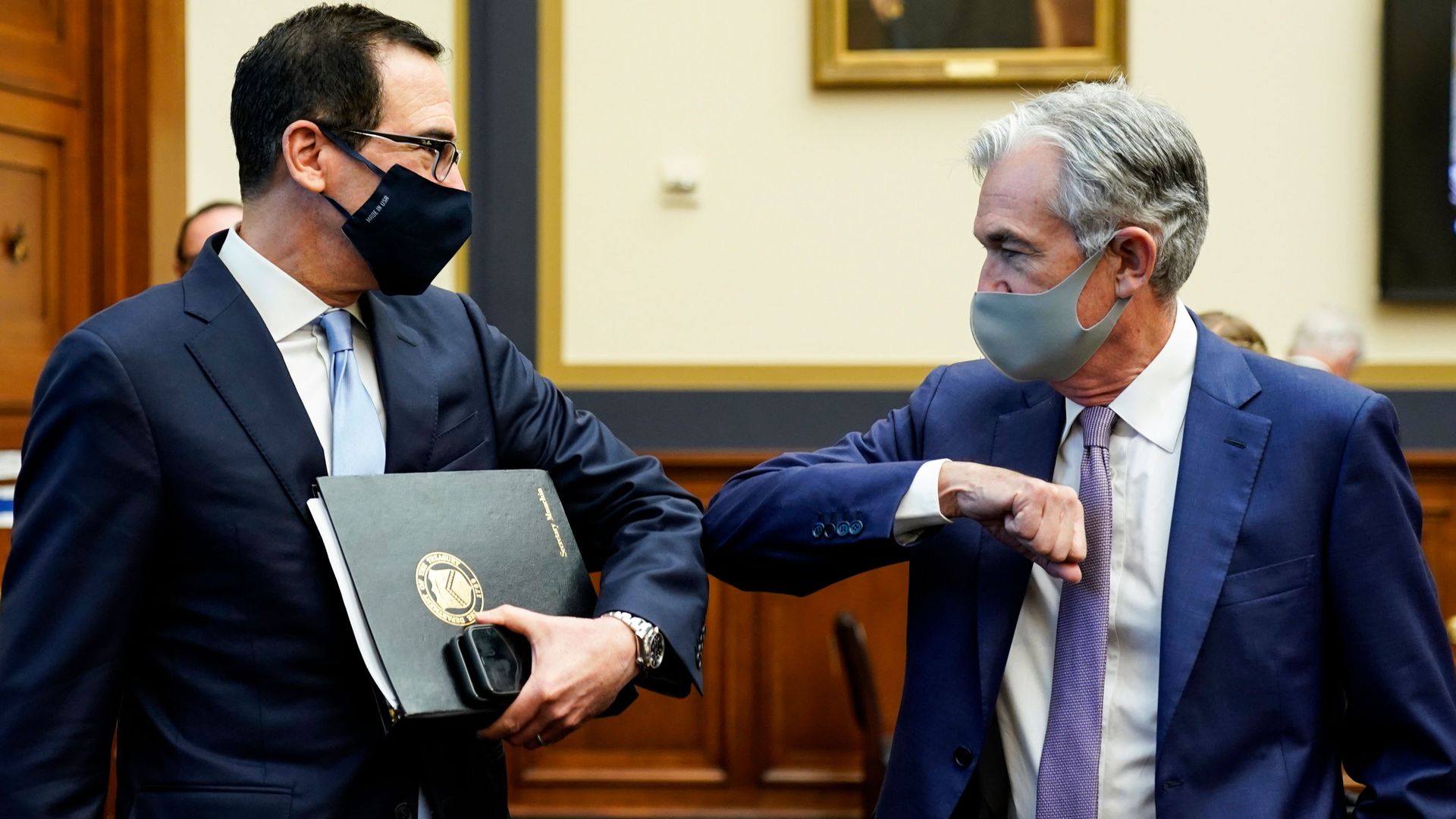 US Treasury Secretary Steven Mnuchin and Federal Reserve Chair Jerome Powell bump elbows before the start of a House Financial Services Committee hearing on Sept. 22 2020