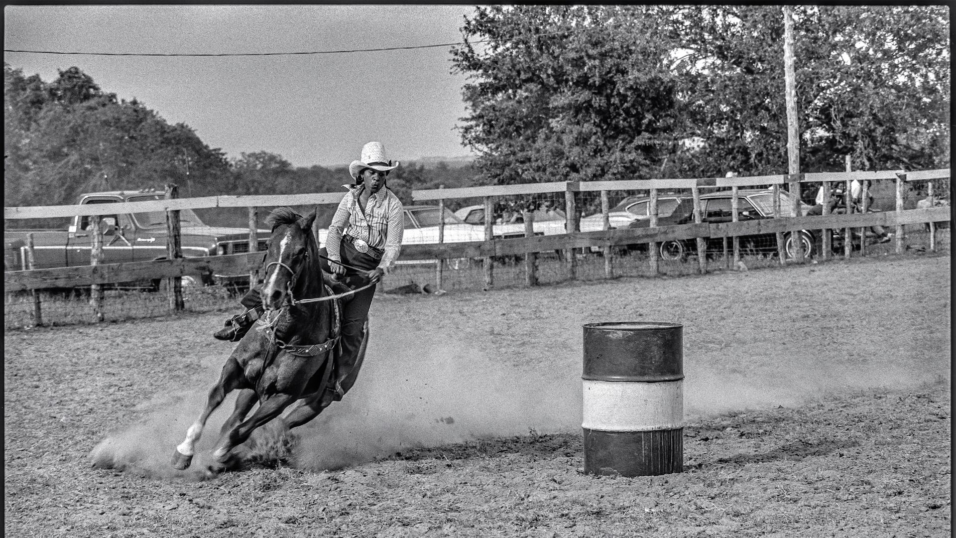 A photo of a person on a horse barrel racing.