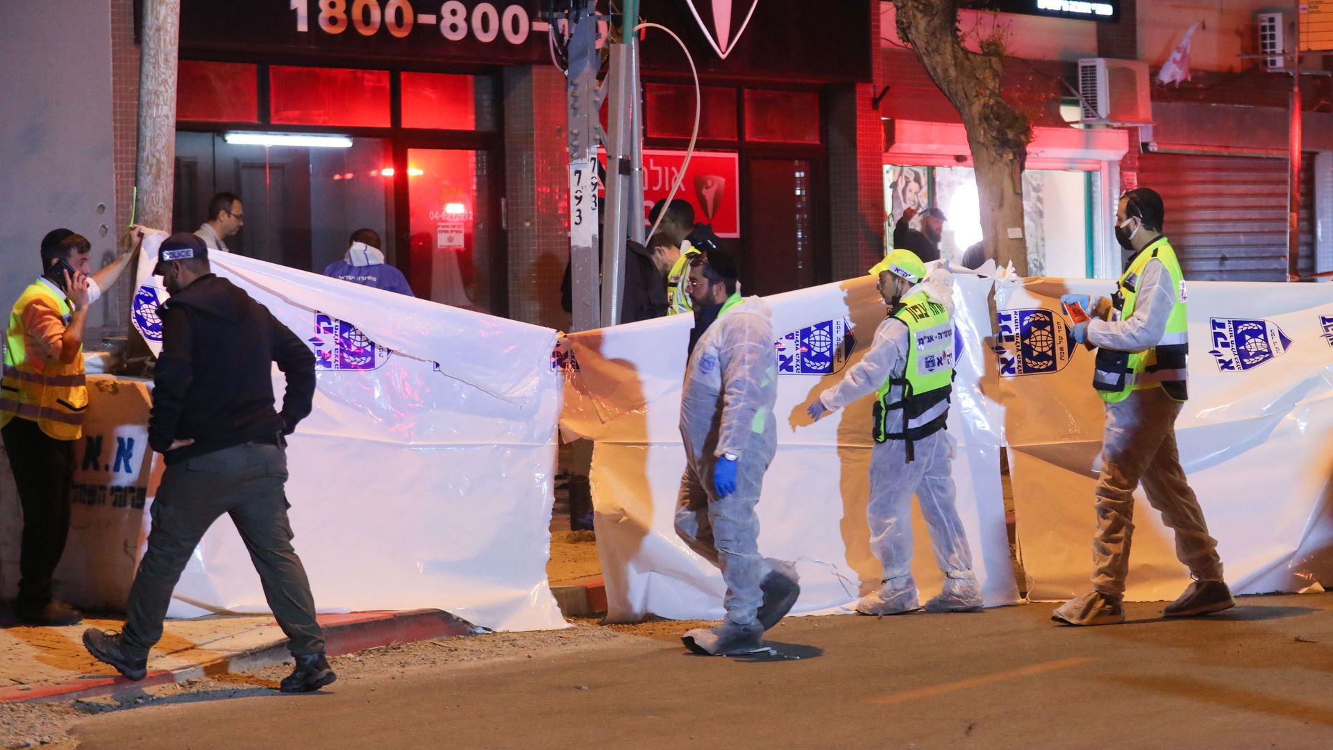 Israeli security forces gather at the site of an attack that left two dead in the city of Hadera on March 27.