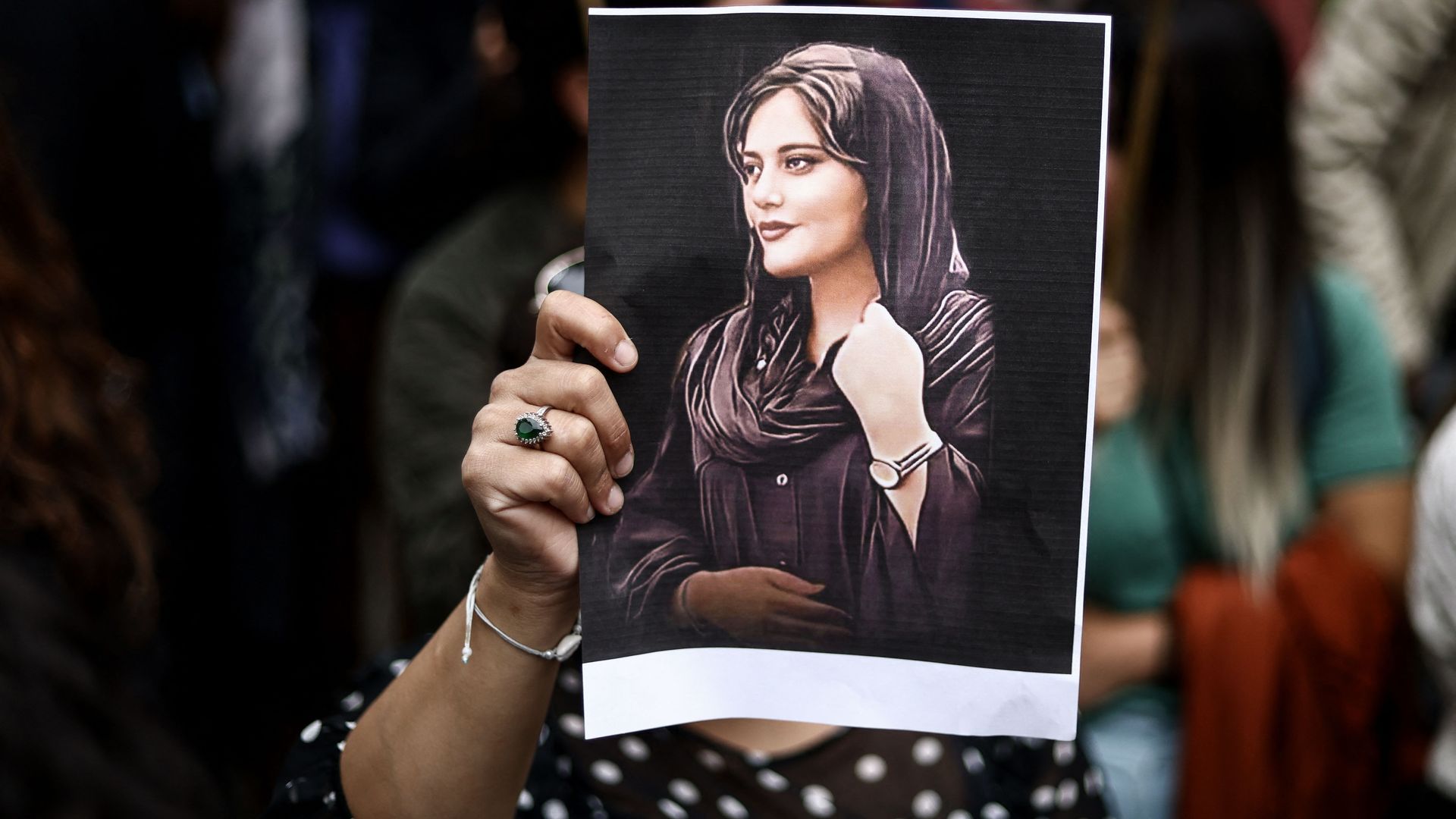  A protester holds a portrait of Mahsa Amini during a demonstration in her support in front of the Iranian embassy in Brussels on September 23.