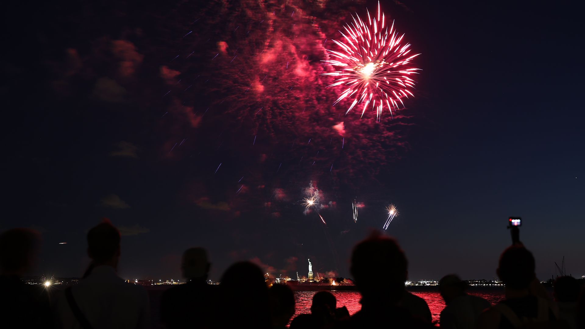 The fireworks to mark the end of the COVID-19 restrictions in New York State and honor frontline workers are seen with the Statue of Liberty in New York City, United States on June 15