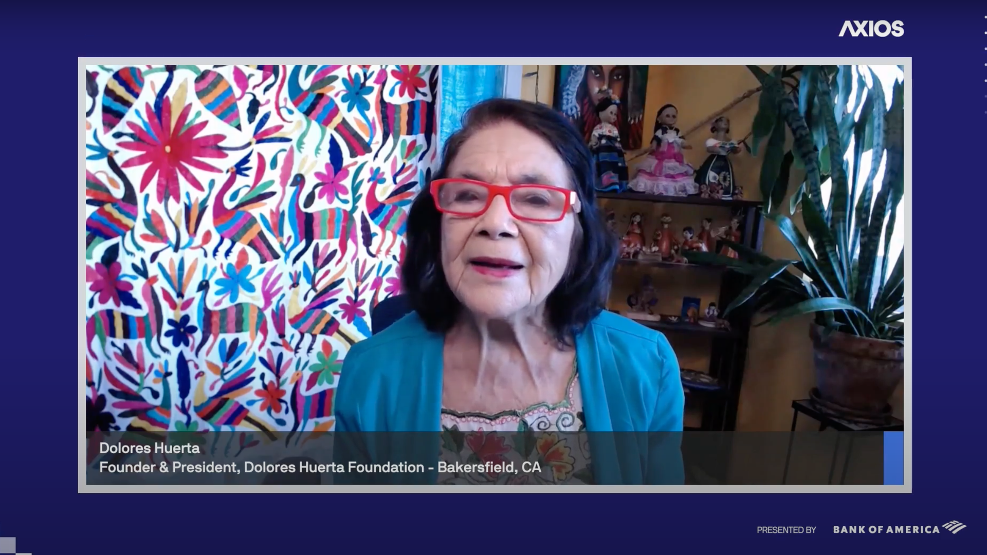 Screenshot of Dolores Huerta sitting in a chair and speaking