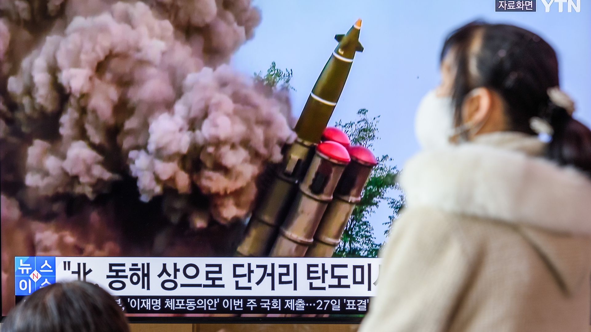 A person watching a tv screen in Seoul on Feb. 20 showing a file image of a North Korean missile launch.