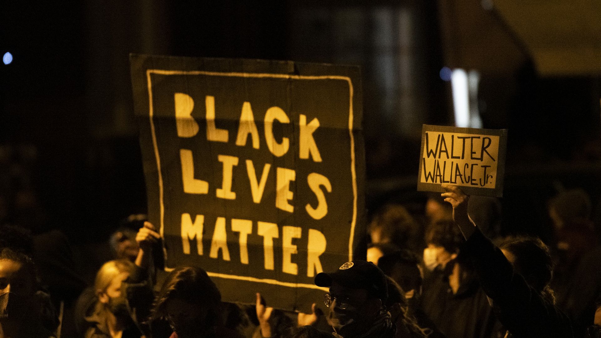 Demonstrators holding placards reading "BLACK LIVES MATTER" and "WALTER WALLACE JR." during a protest . Photo: Mark Makela/Getty Images