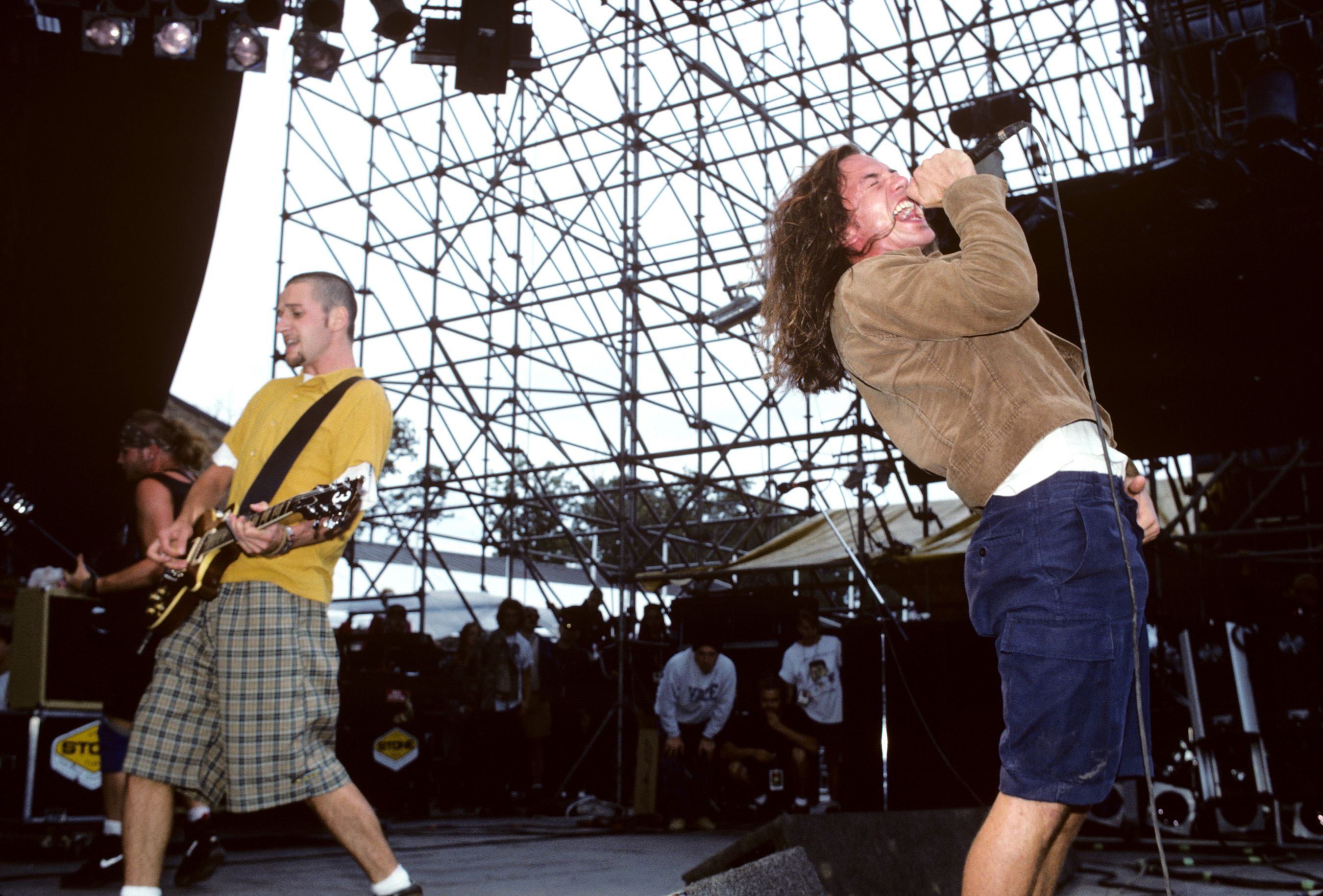 The members of Pearl Jam perform on stage in 1992. 