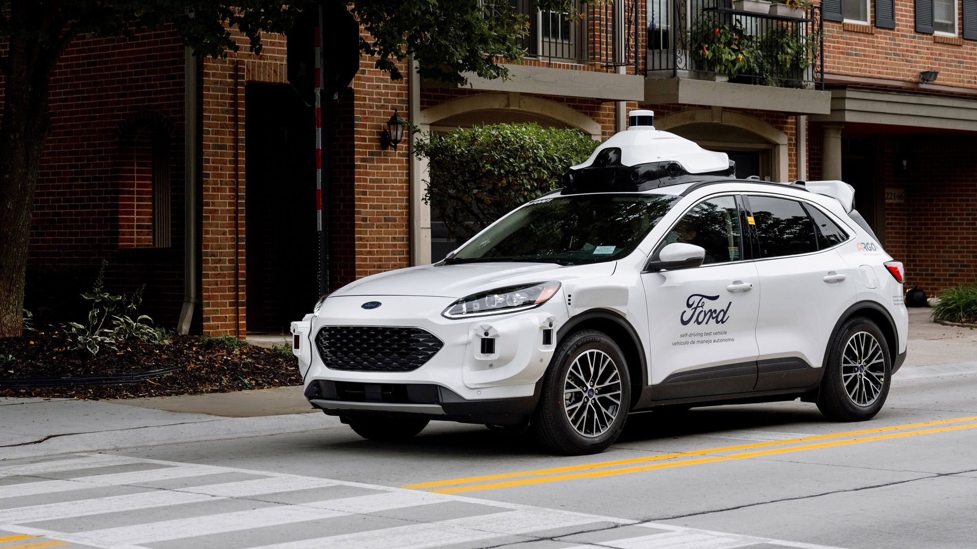 Image of Ford's 4th generation self-driving vehicle, a Ford Escape Hybrid equipped with lidar and other sensors.