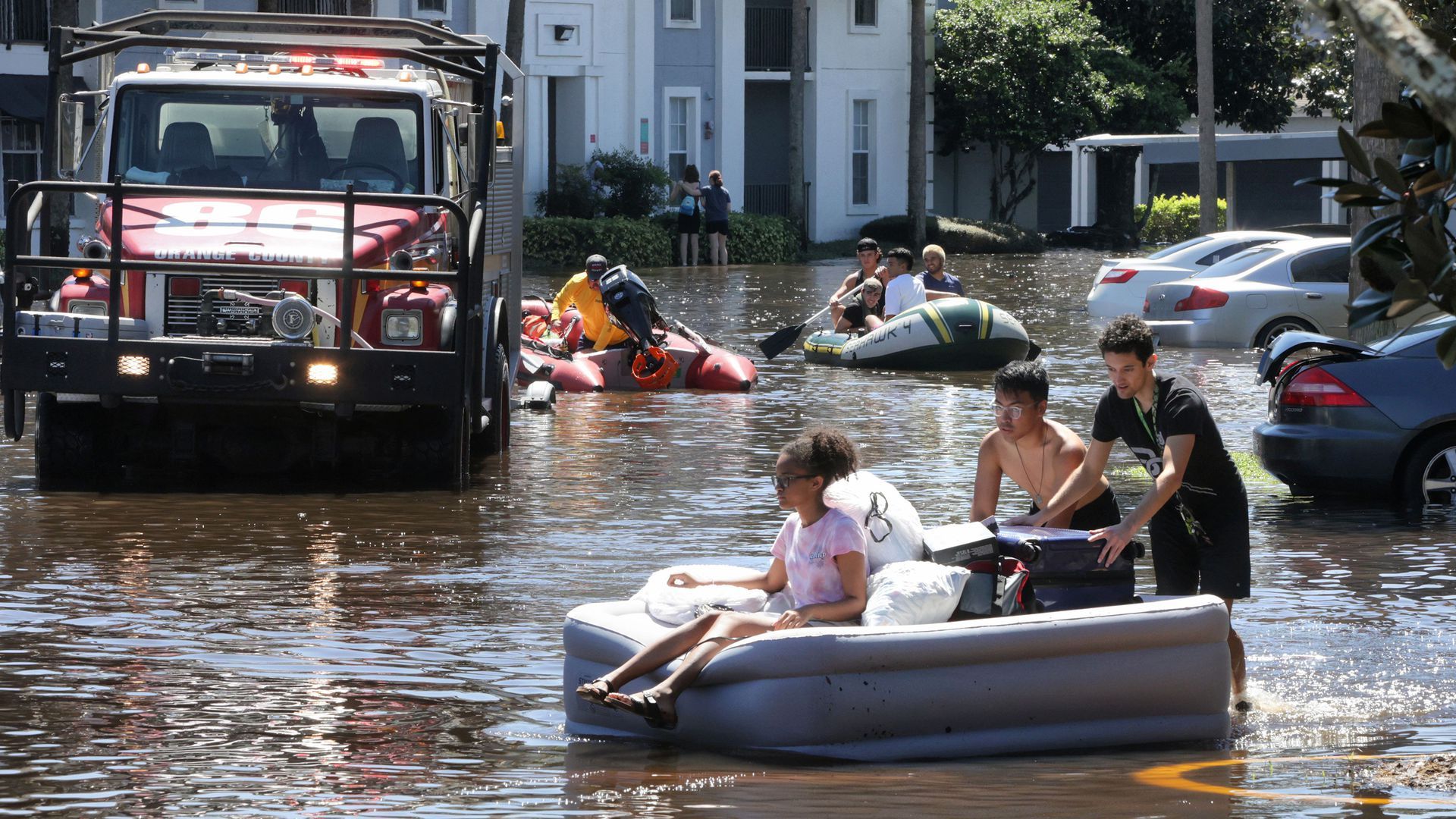 Residents of a flooded neighborhood in Florida use an air mattress to carry belongings out of their homes, Sep. 30. Photo: Joe Burbank/Orlando Sentinel/Tribune News Service via Getty Images