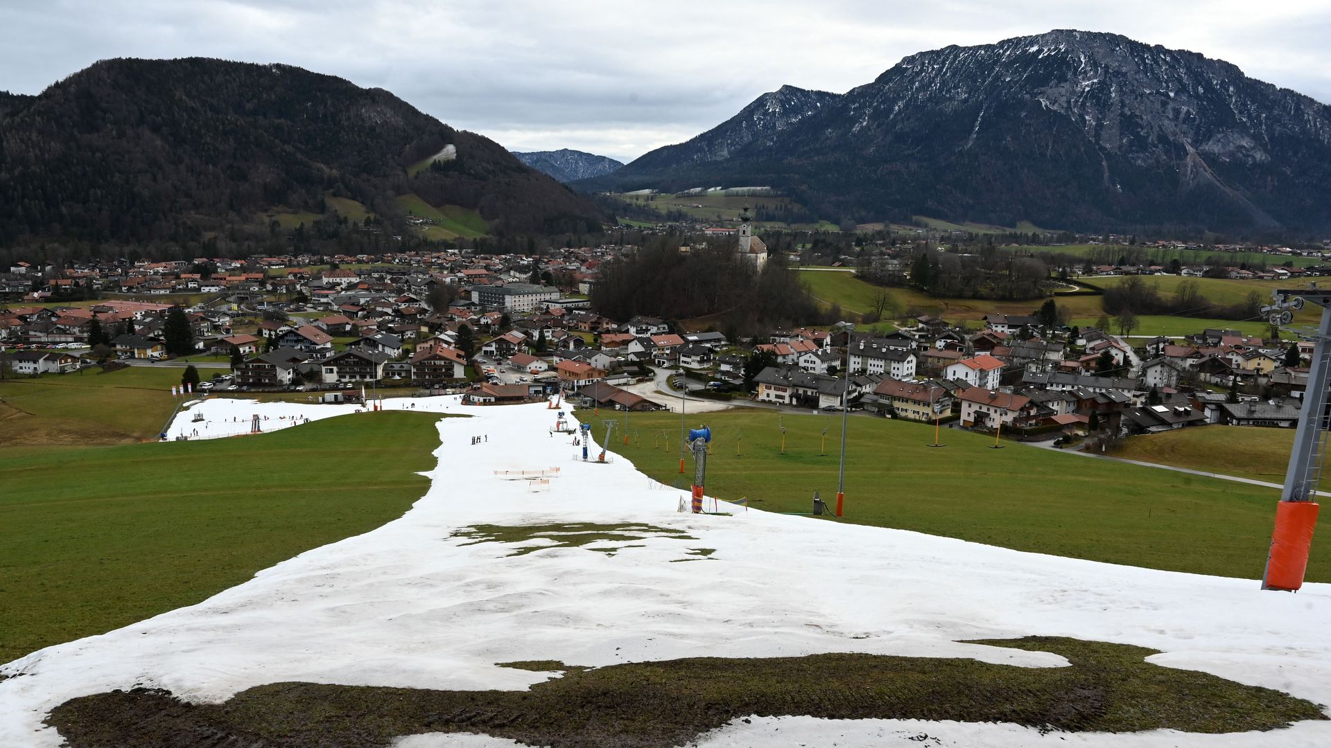 A patchy artificial snow hill is pictured near the Bavarian village of Ruhpolding, southern Germany, on January 11, 2023
