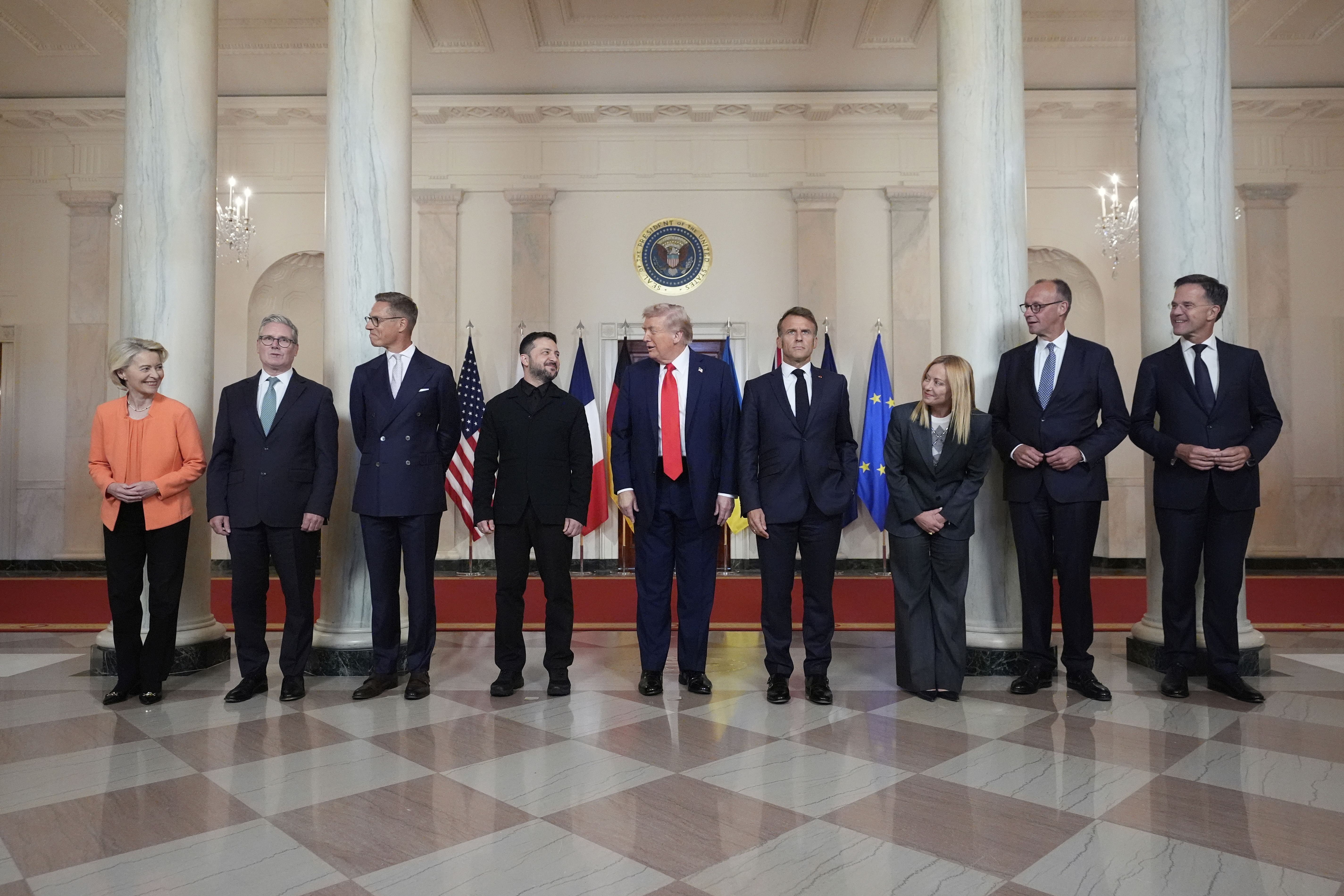 President Trump and Ukrainian President Volodymyr Zelensky pose with seven European leaders for a group photo in the White House.