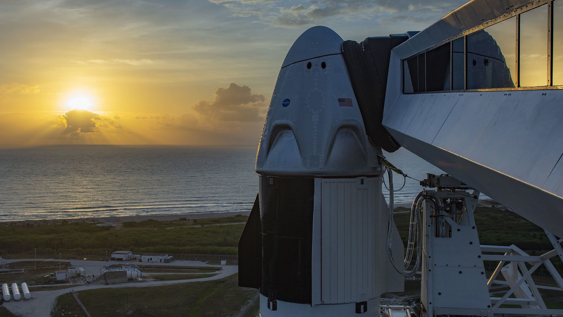SpaceX's Crew Dragon atop a Falcon 9 rocket in the light of the morning. 