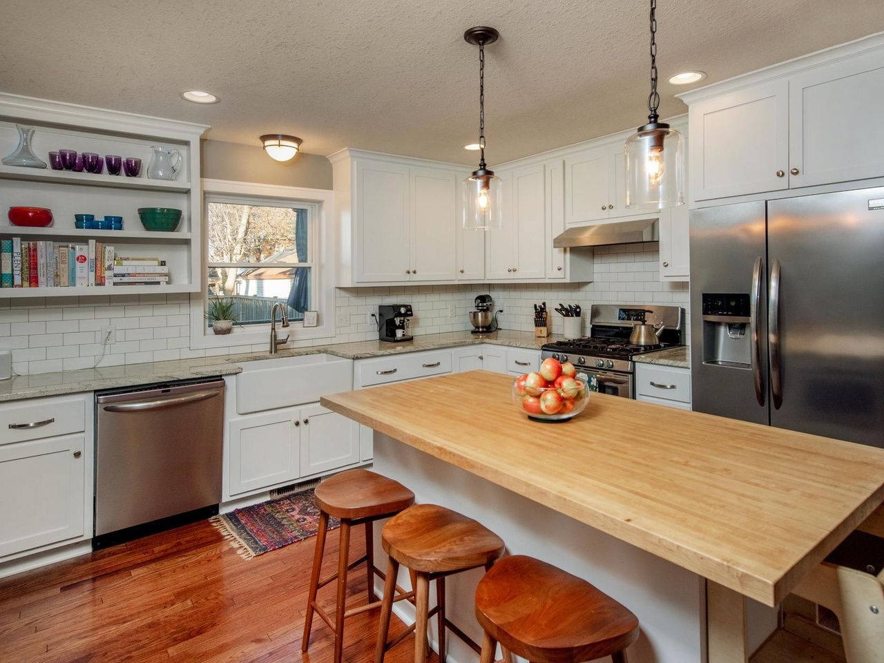 modern kitchen with butcher block island and built in shelving