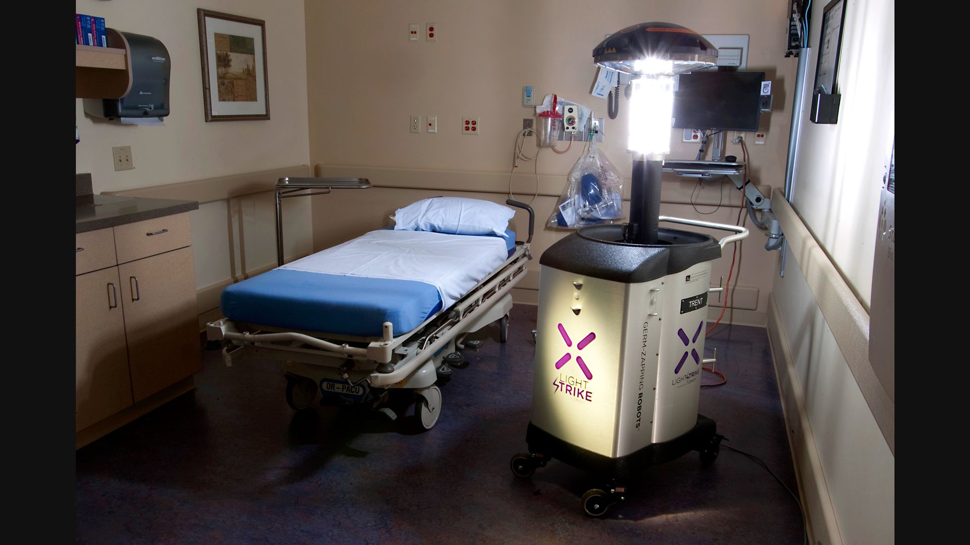Image of Xenex ultra-violet robot disinfecting a hospital room. 