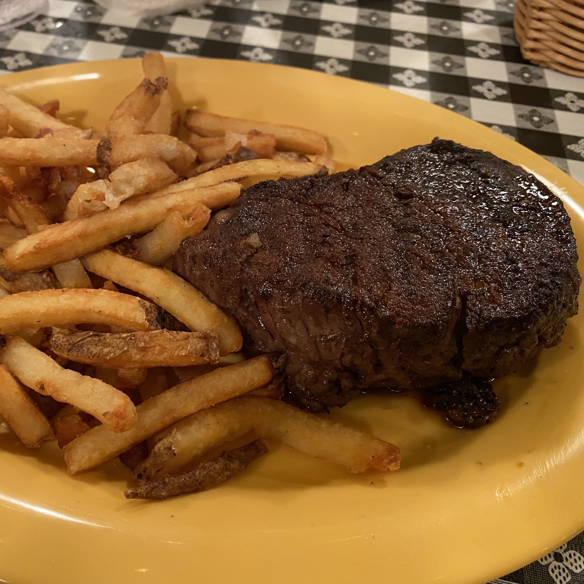 A plate with a steak and french fries. 