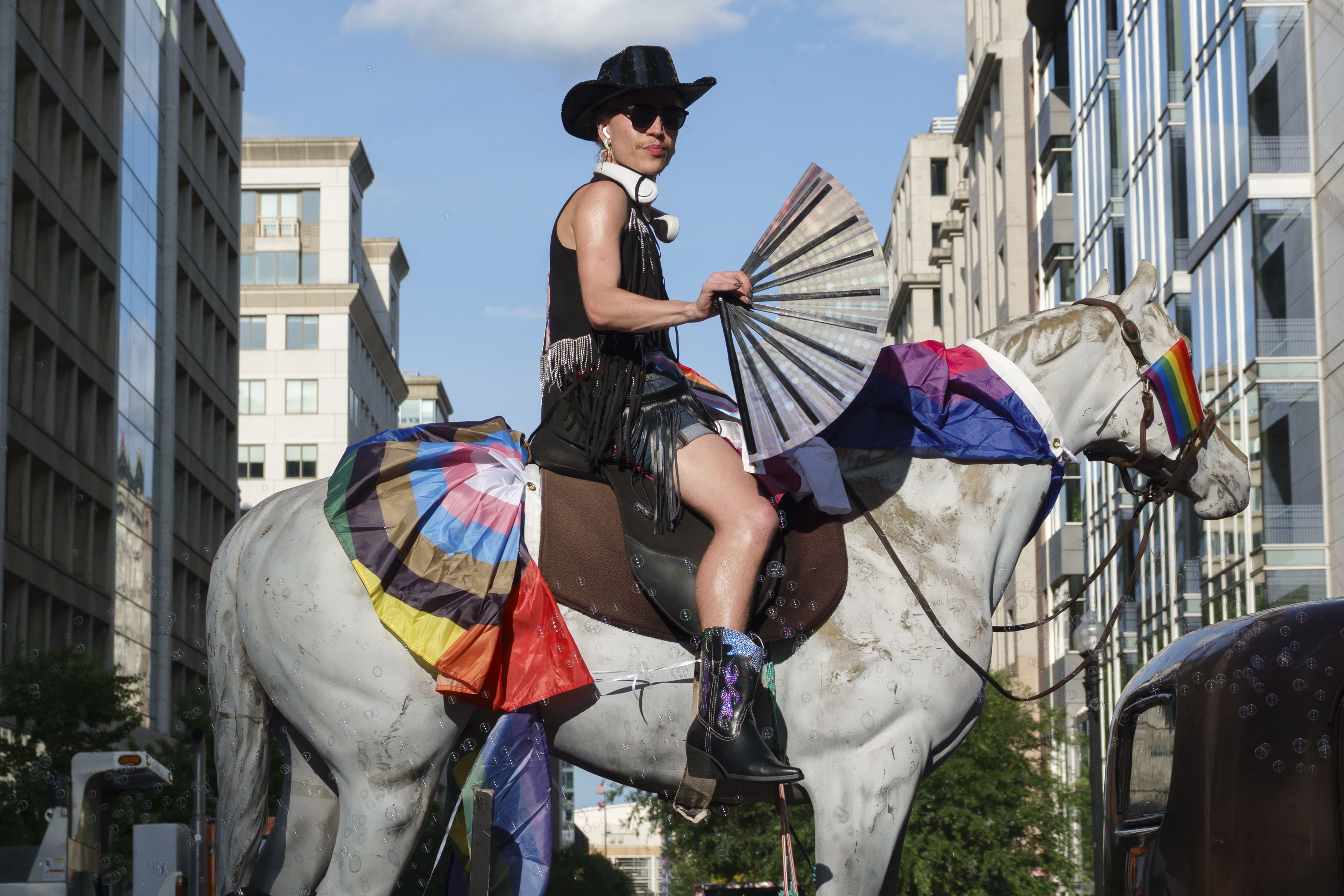 A person sits on a fake horse on a float in the WorldPride Parade on June 7, 2025 in Washington, DC. This year marks the 50th Anniversary of Pride celebrations in Washington, DC and is host to WorldPride 2025. (Photo by Kevin Carter/Getty Images)
