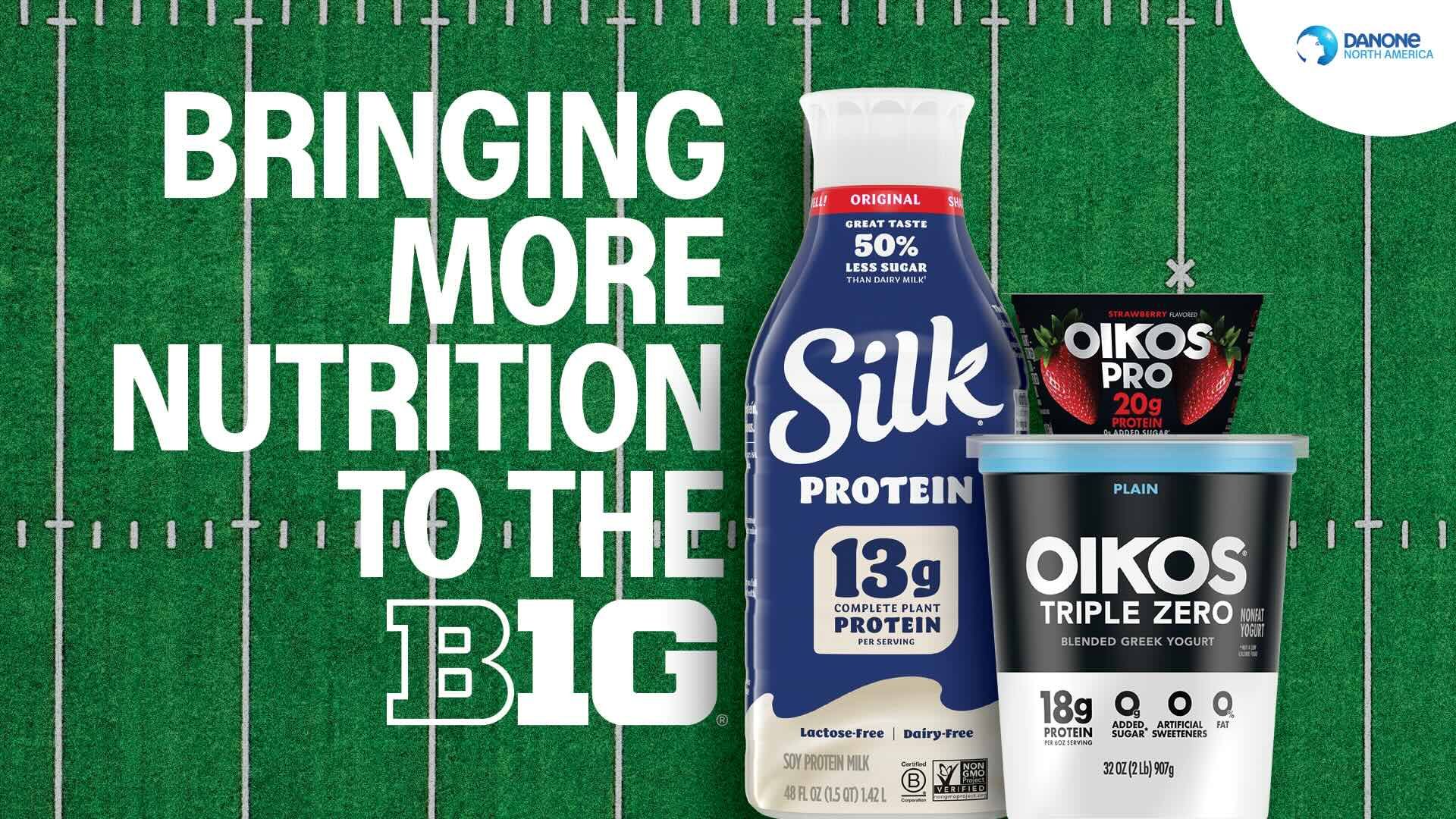 Green football field background with white yard lines, SilK protein soy milk bottle, Oikos Pro strawberry yogurt, and Oikos Triple Zero plain yogurt, with text "Bringing more nutrition to the Big".