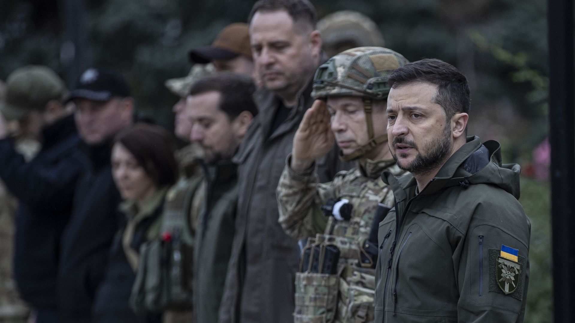 Photo of Volodymyr Zelensky standing next to a line of soldiers
