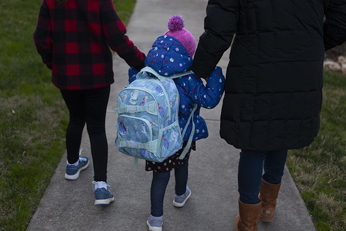 Dana Mackay and daughter walk into daycare