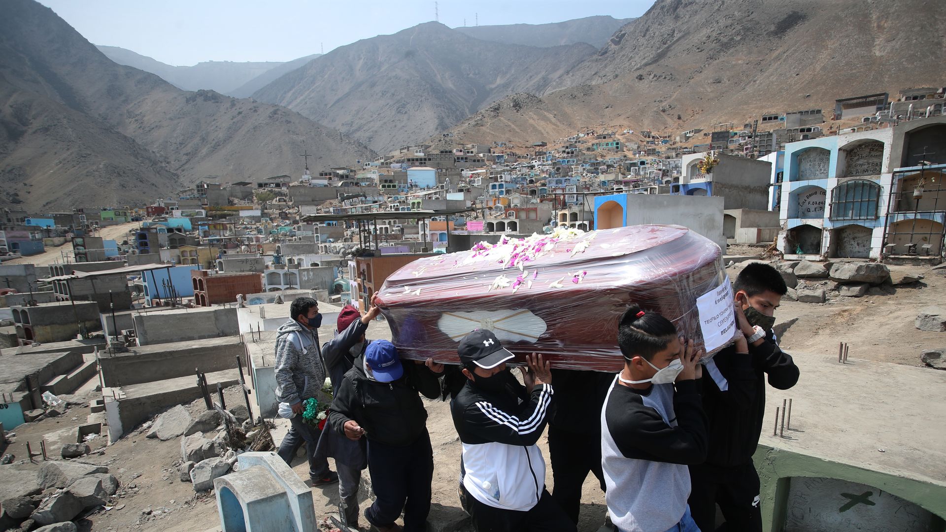 Relatives of Teofilo Yovera Yarleque, 72, who they say died of COVID-19, carry his coffin for burial at the cemetery "Martires 19 de Julio" on August 20, 2020 in Comas, in the outskirts of Lima, Peru