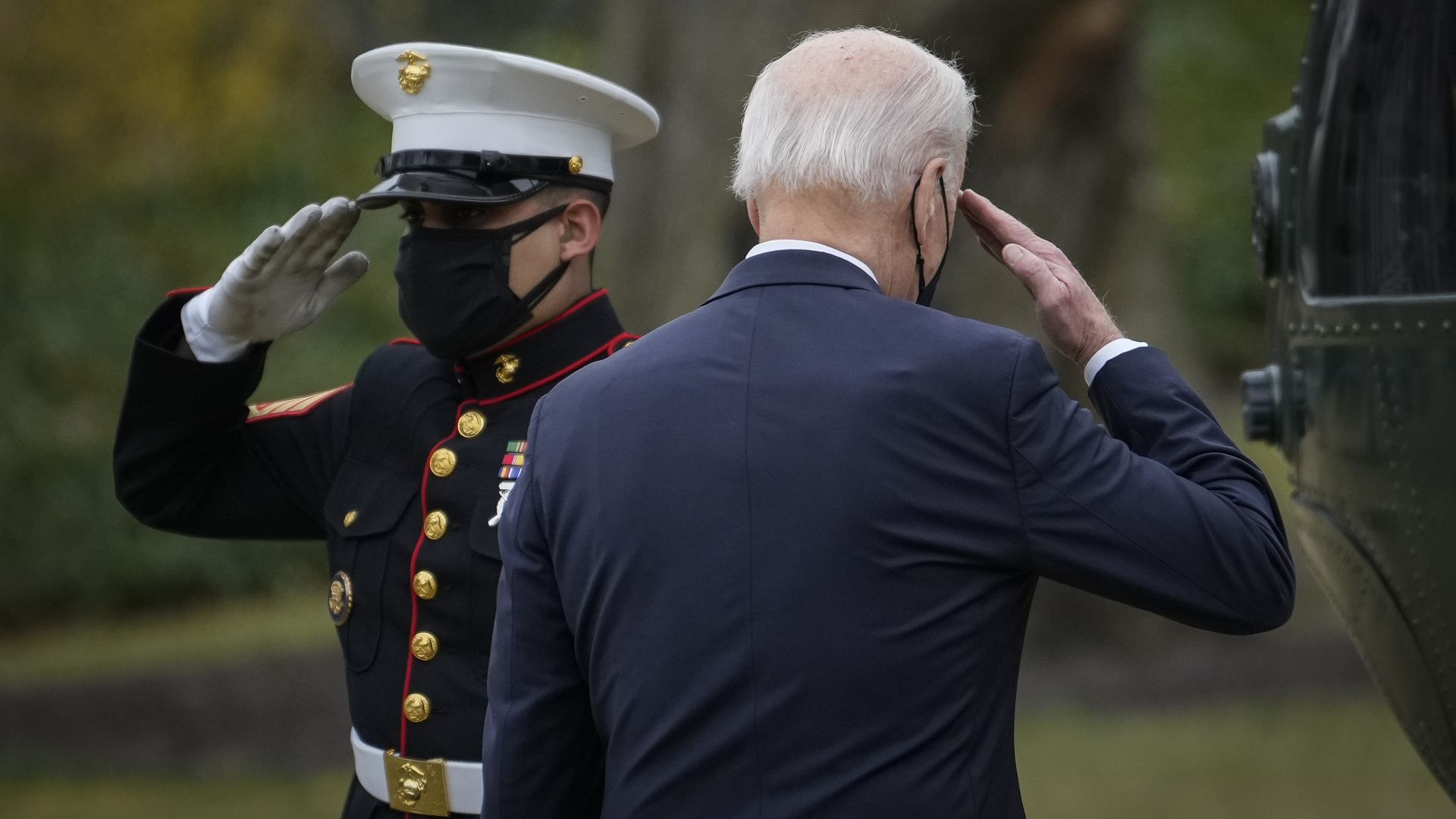 President Biden is seen saluting a Marine as he boards Marine One.