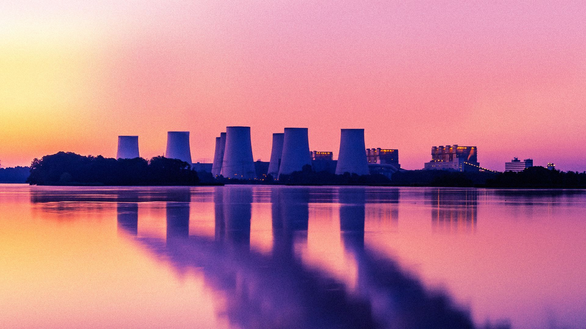 Illustration of a skyline showing a nuclear plant on a waterfront with emissions from the towers only visible in the water's reflection.