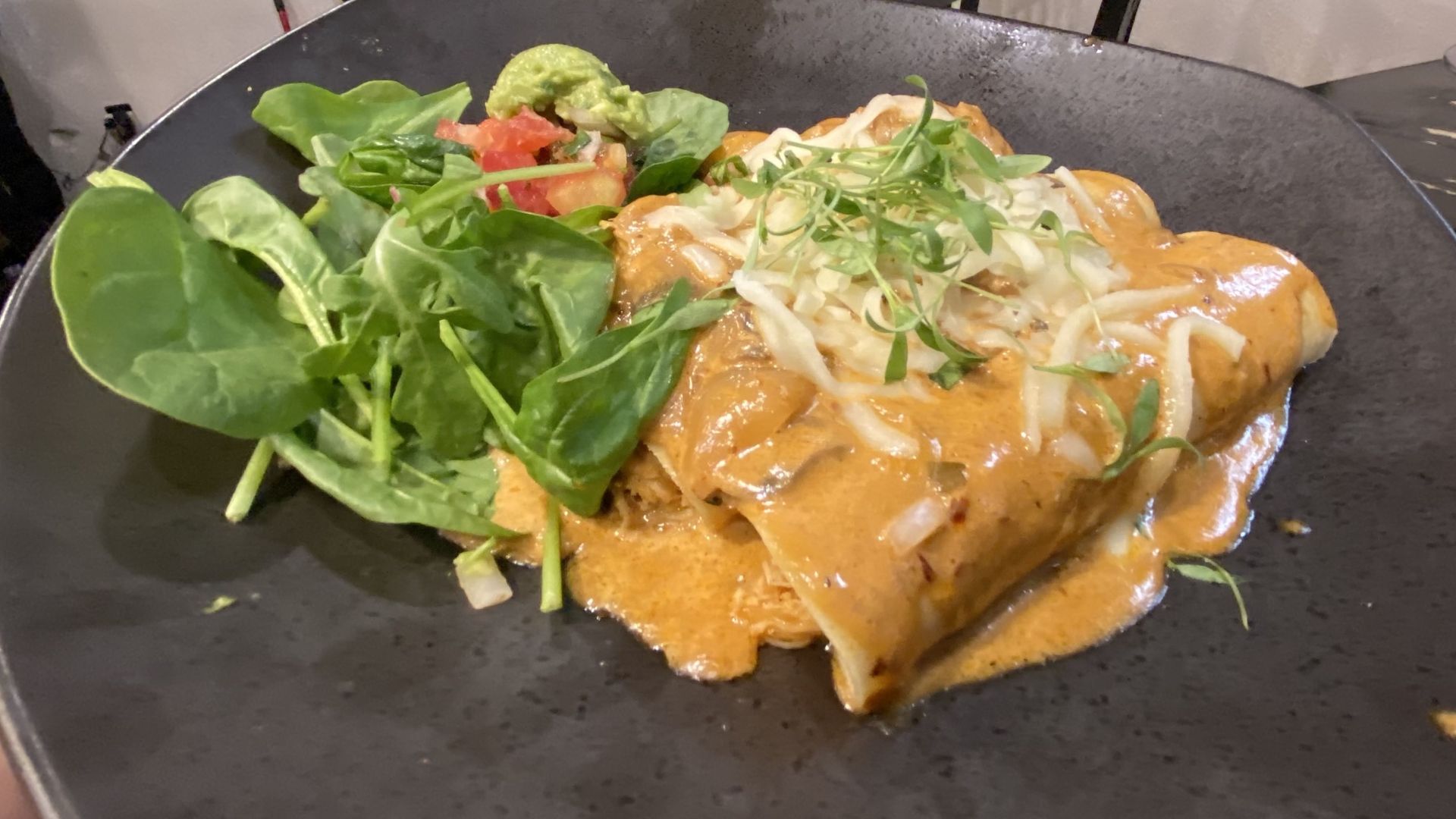 A photo of a plate of enchiladas.