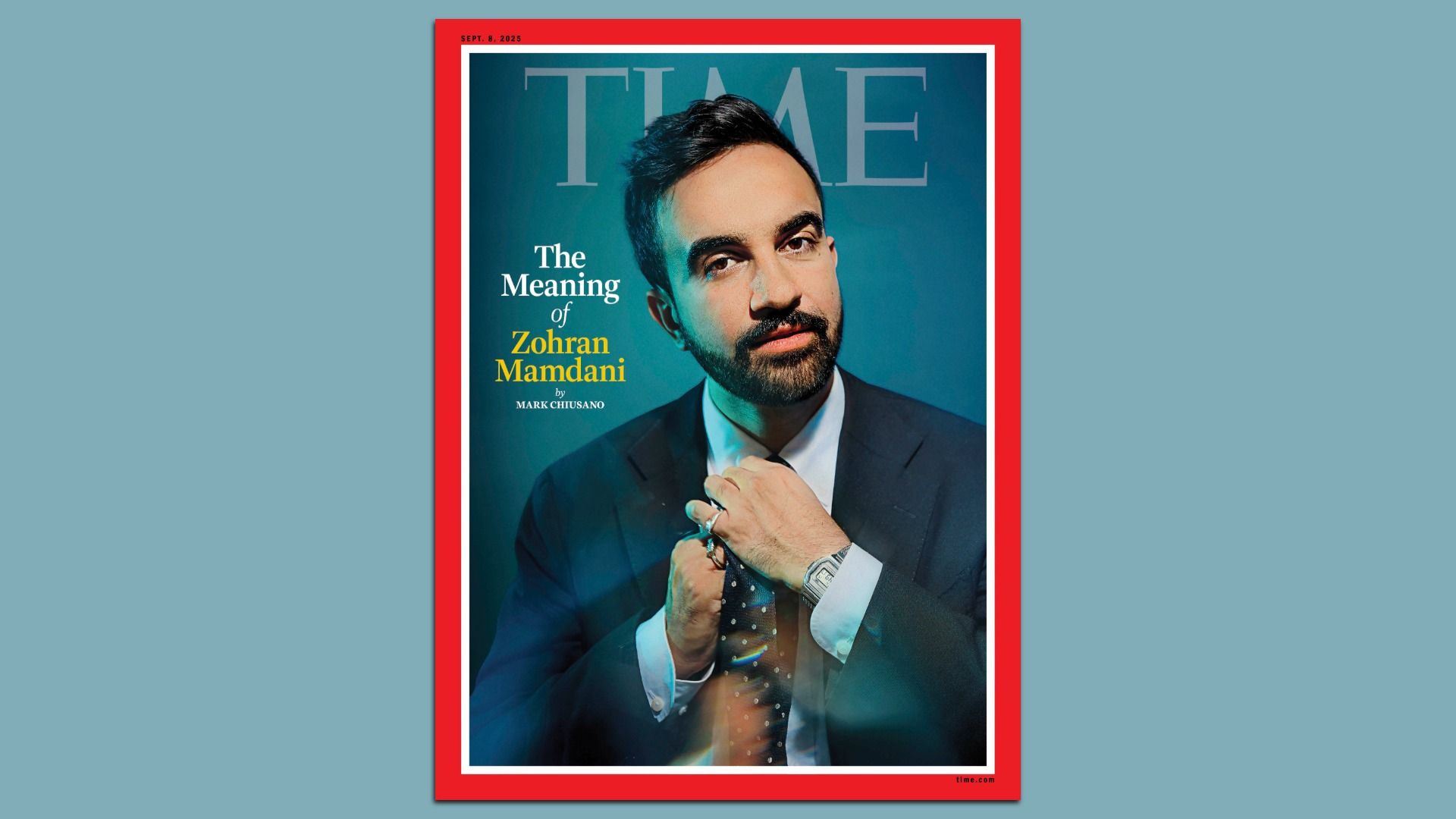 TIME magazine cover featuring Zohran Mamdani adjusting his tie, with a blue background and a red border. Headline reads "The Meaning of Zohran Mamdani" by Mark Chiusano.