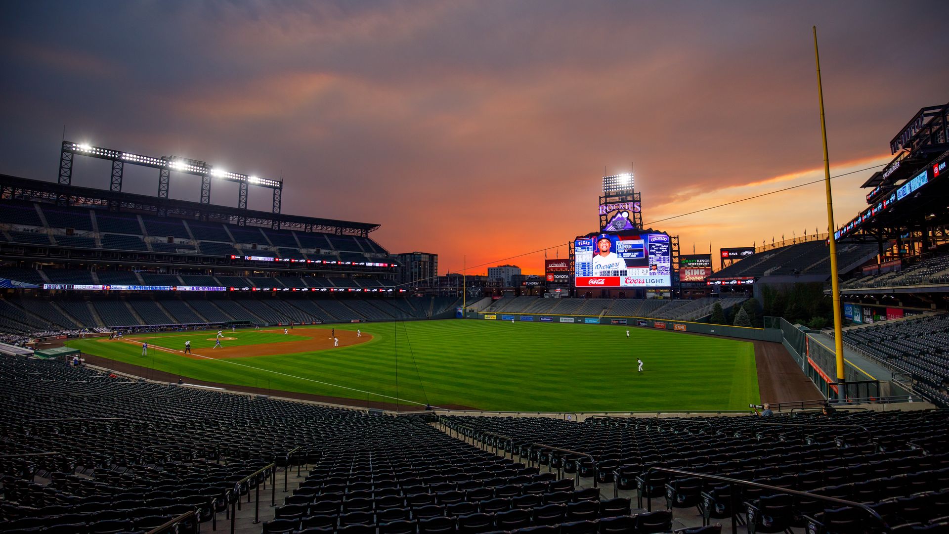 Coors field with a sunset.