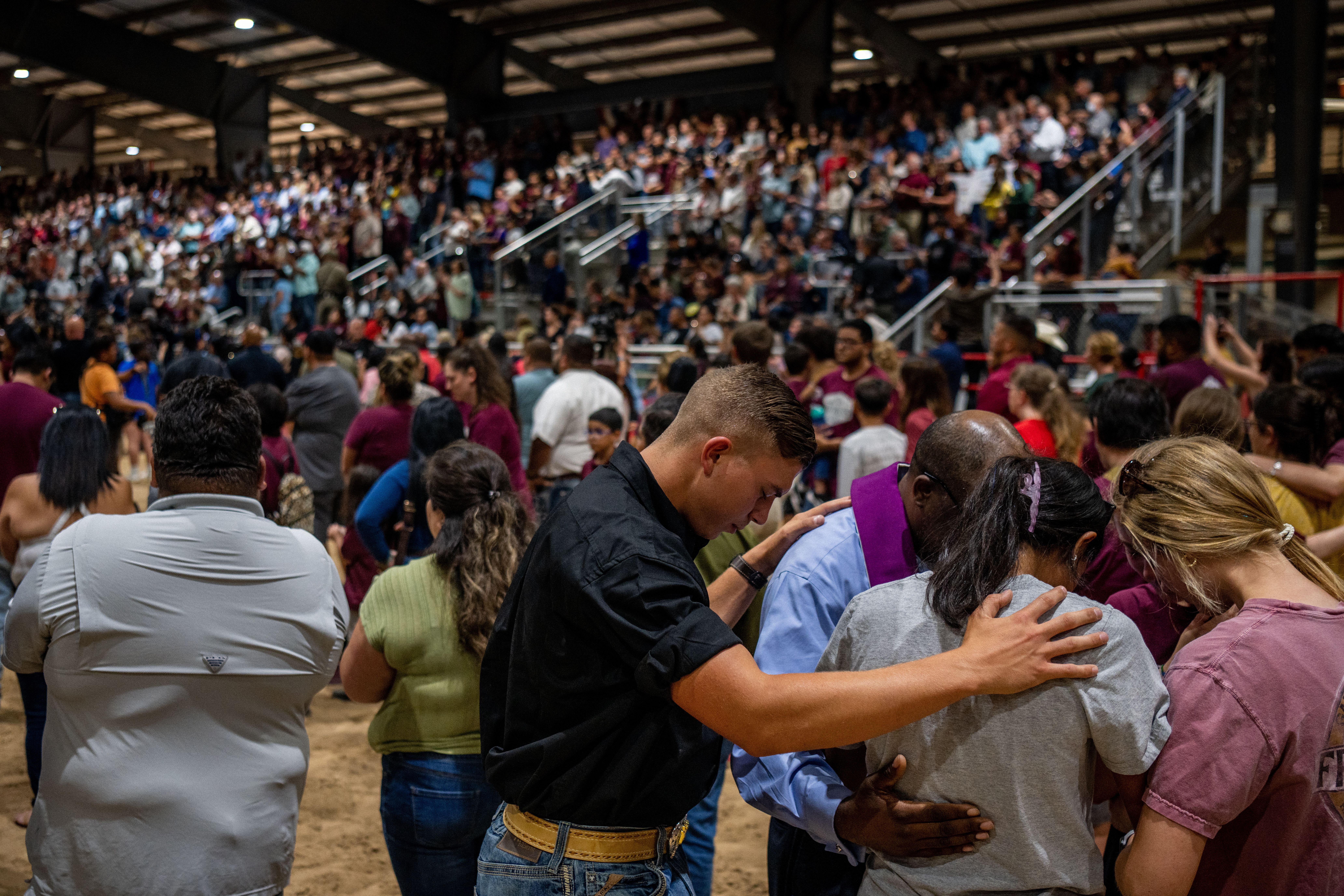 Community members pray together at a vigil for the 21 victims in the mass shooting at Rob Elementary School on May 25, 2022 in Uvalde, Texas.