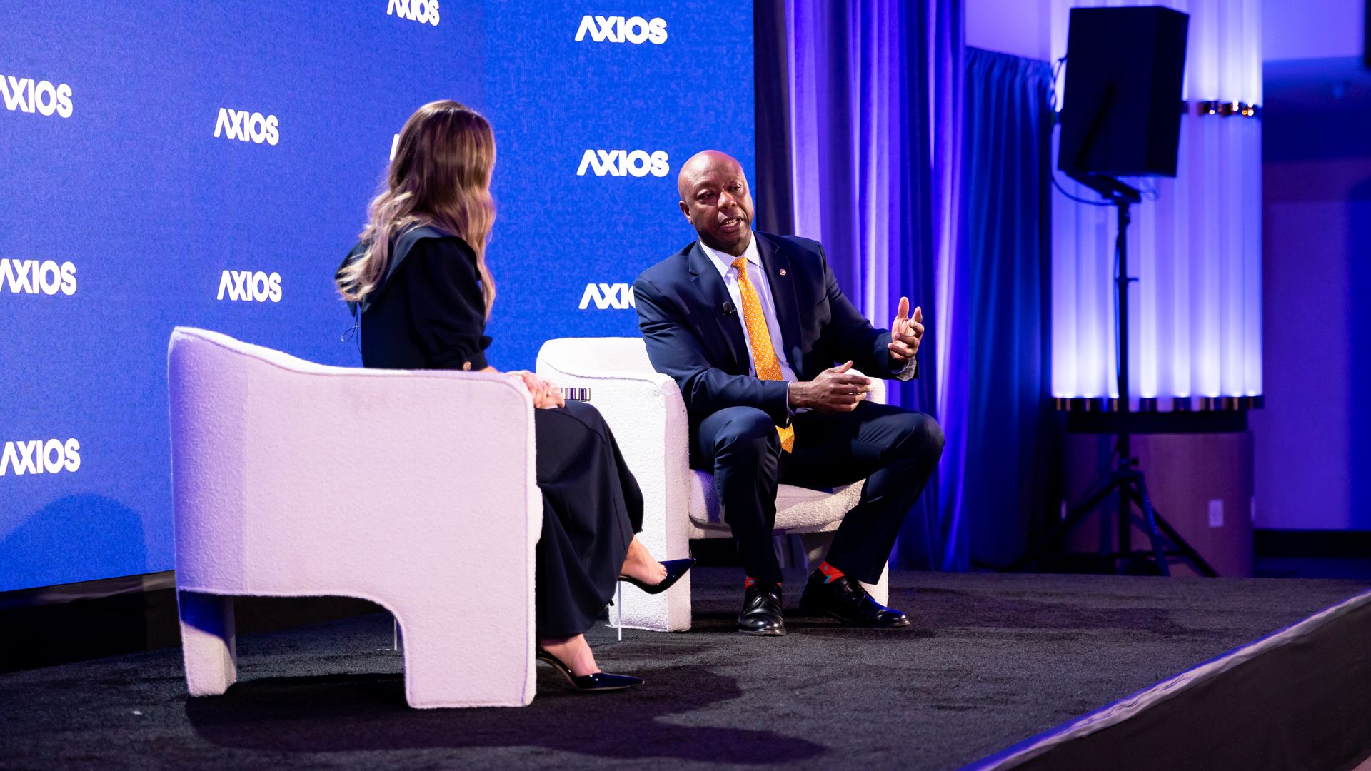 Sen. Tim Scott (R-S.C.) speaks with an Axios reporter on stage for the summit conversation about crytpo currency and the 2026 election cycle