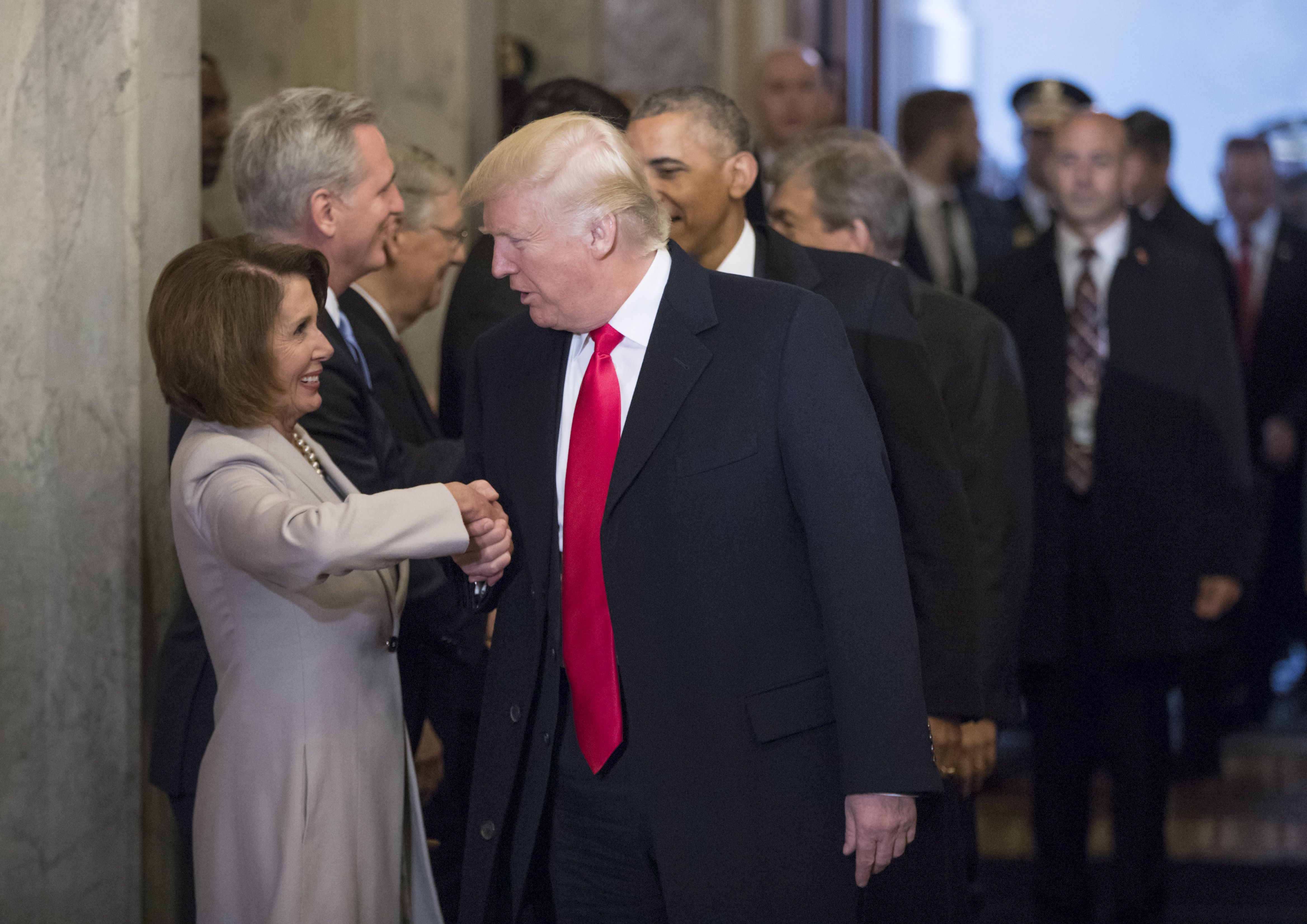 Nancy Pelosi shakes hands with Donald Trump as he arrives at the Capitol with President Obama for the 2017 inauguration ceremony.