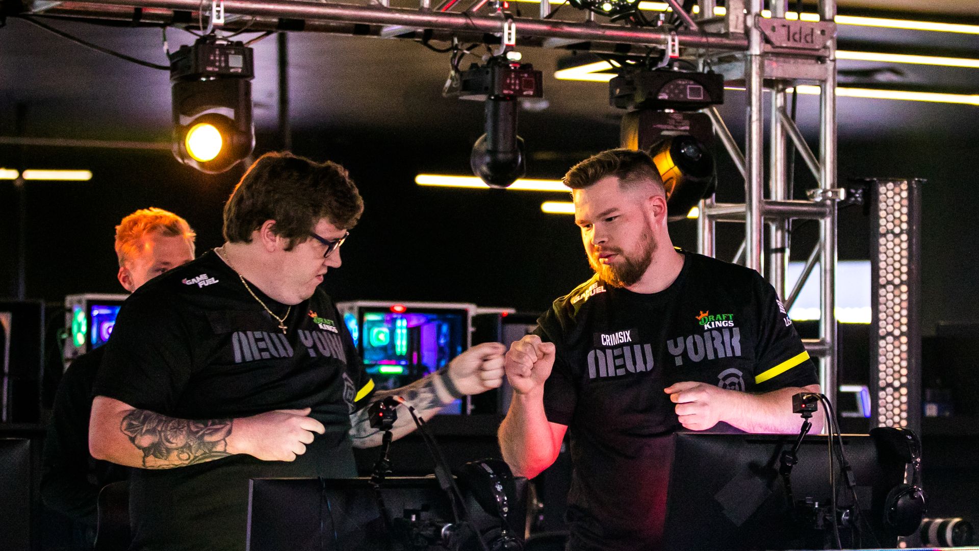 Two video game players fist-bump at a Call of Duty tournament.