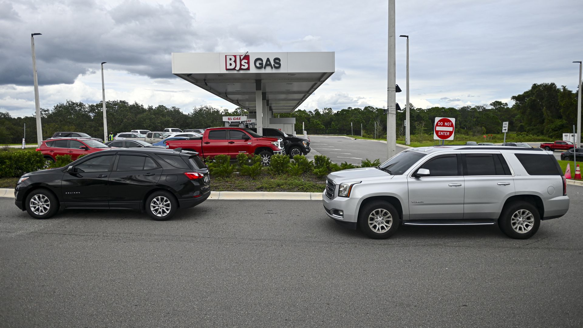 People line up in their cars for fuel at a gas station ahead of Hurricane Milton's expected landfall in Lakeland, Florida on October 8, 2024. Storm-battered Florida girded Tuesday for a direct hit from Hurricane Milton, a monster weather system threatening catastrophic damage and forcing President J