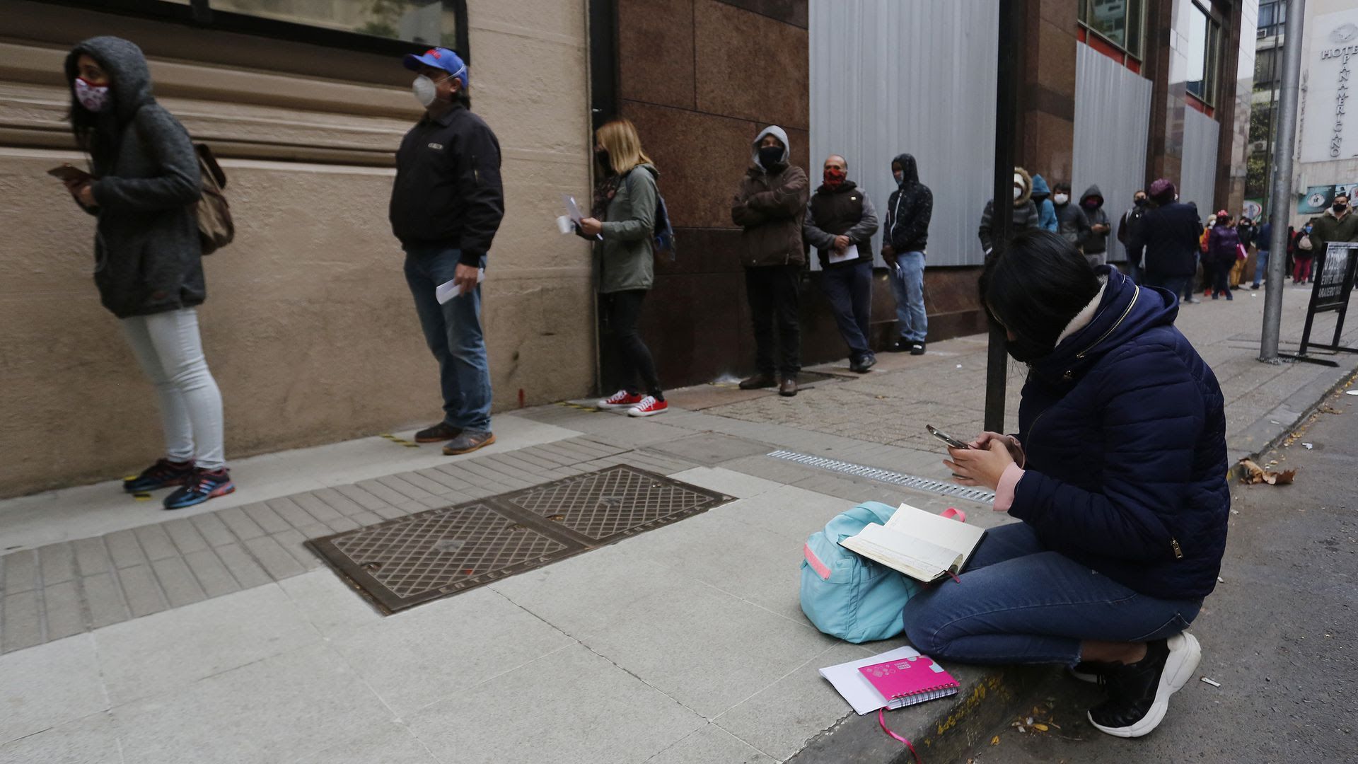 People wait in a long line to file for unemployment