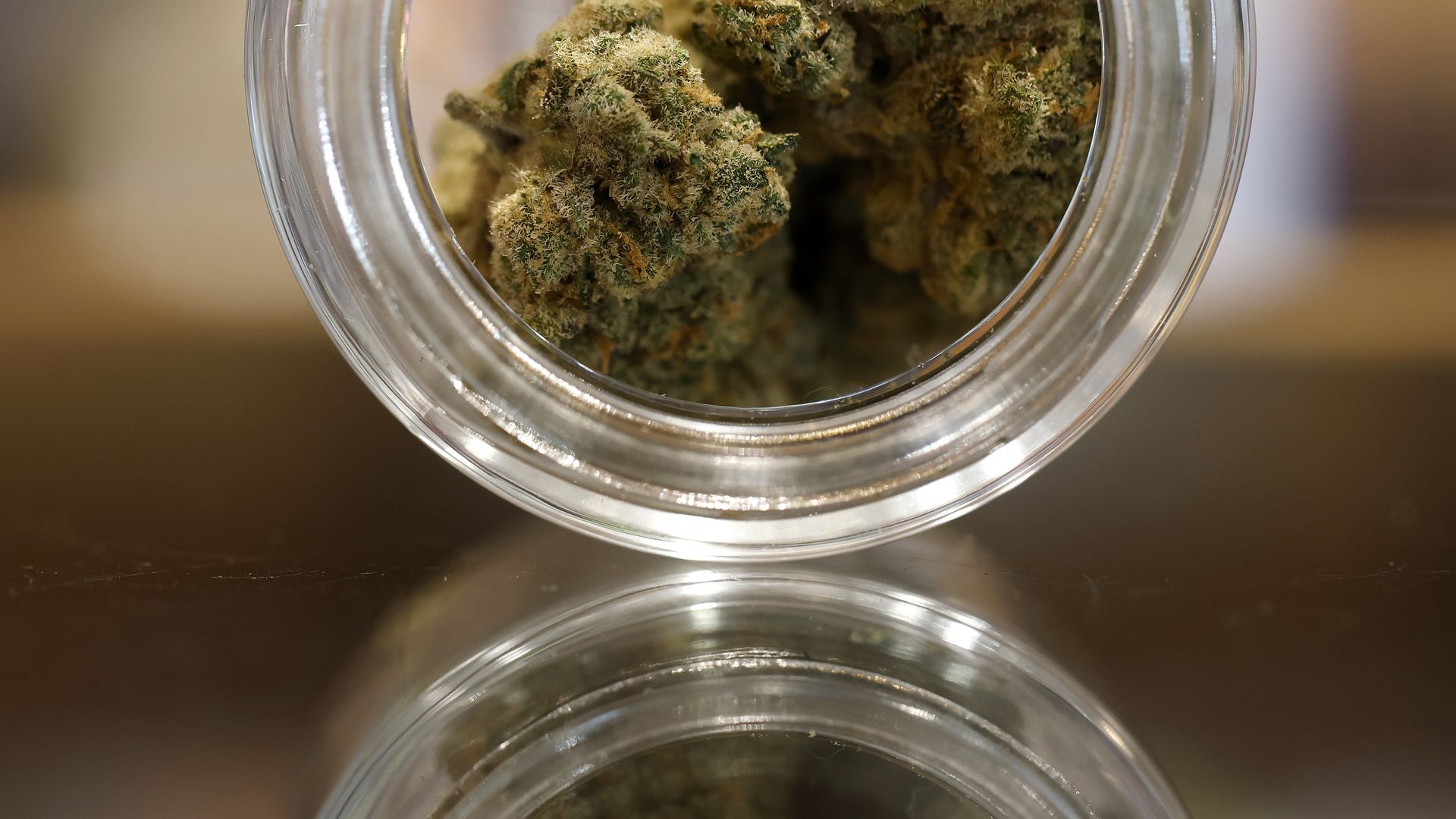 Cannabis shown for sale in a clear jar.