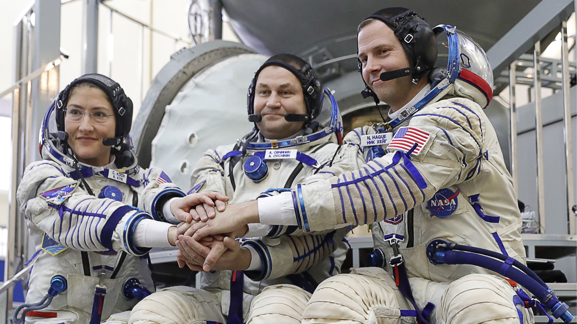 Three astronauts preparing for a mission