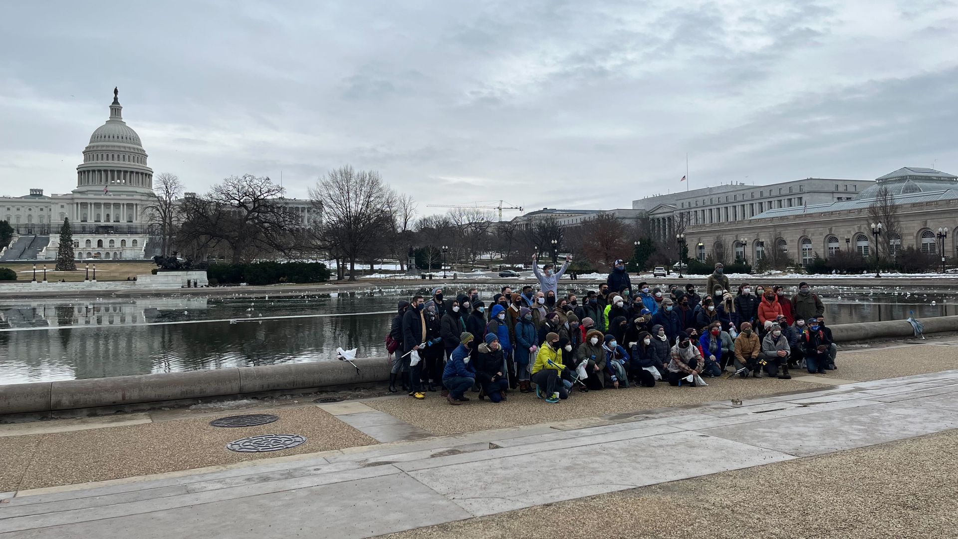 A large group poses outside the Capitol. 