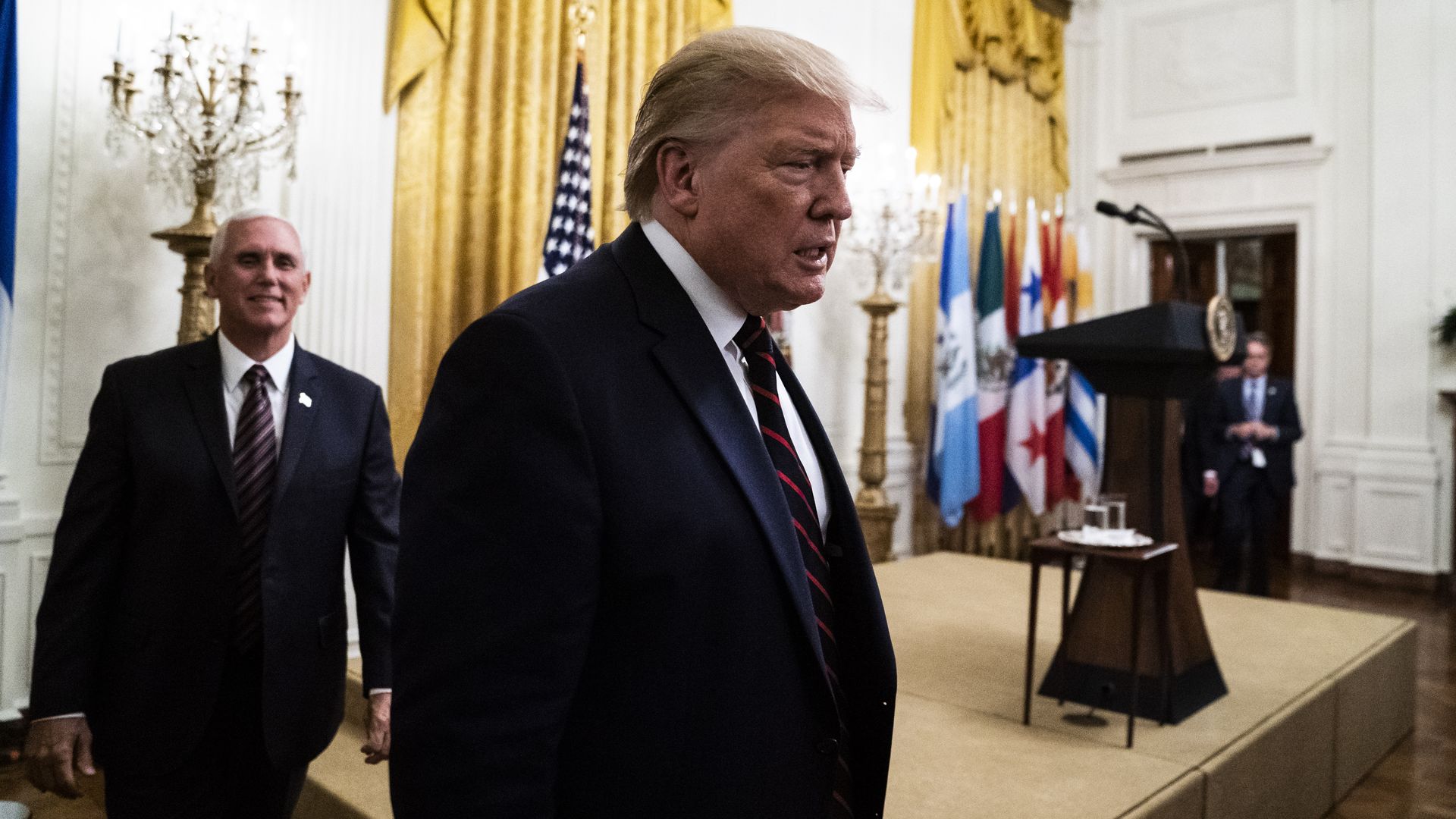Trump walking with Pence behind him.