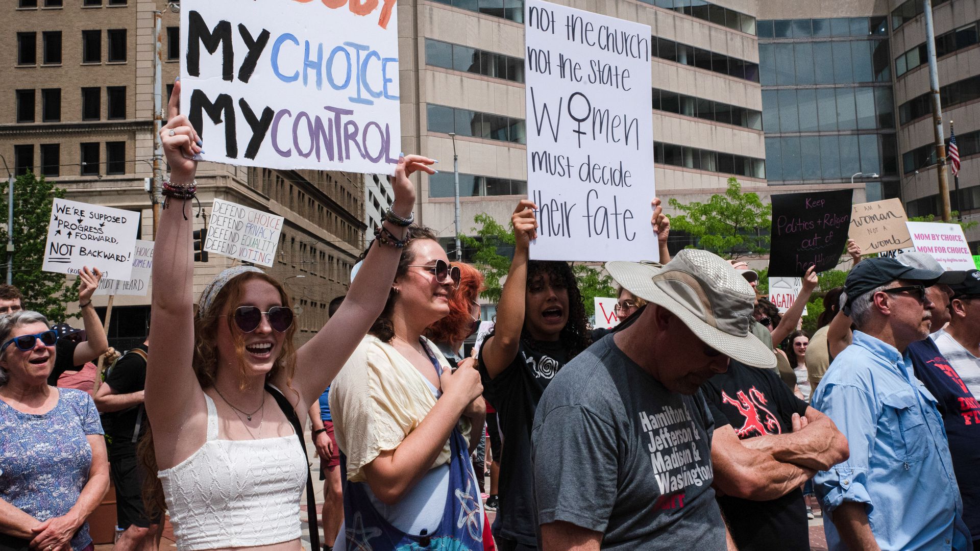 Protestors hold up signs during a rally in downtown Dayton, Ohio.