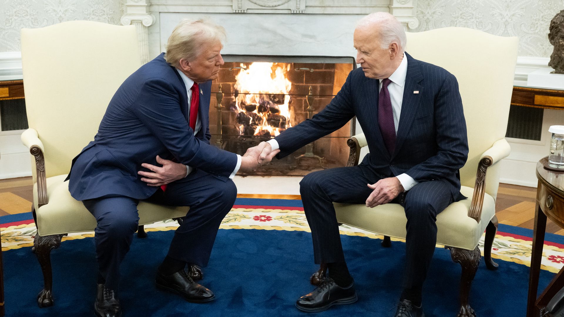 Joe Biden shakes hands with US President-elect Donald Trump during a meeting in the Oval Office of the White House in Washington, DC, on November 13