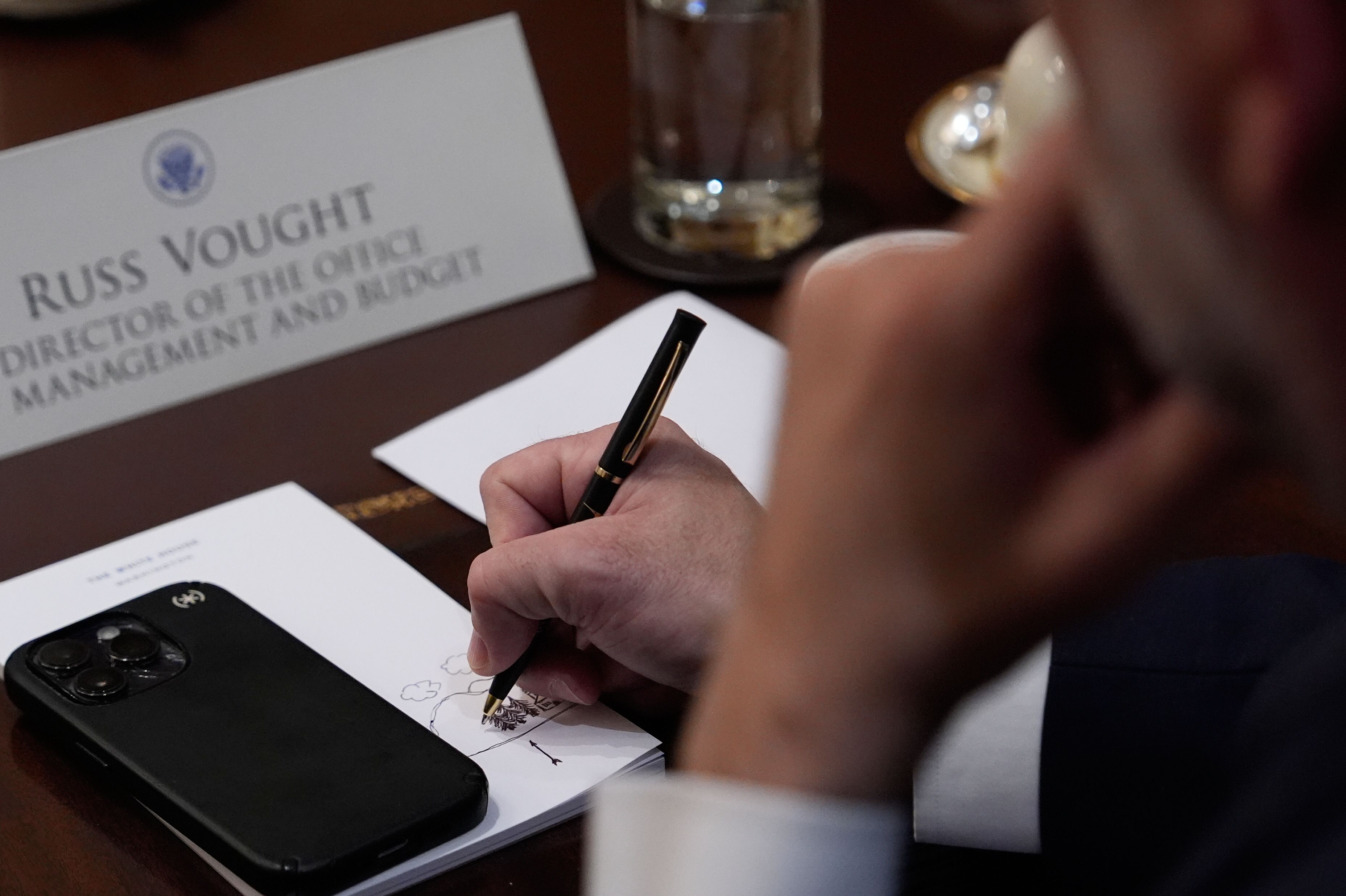 Russ Vought, director of the Office of Management and Budget, doodles during a marathon two-hour-long Cabinet meeting in the White House yesterday.