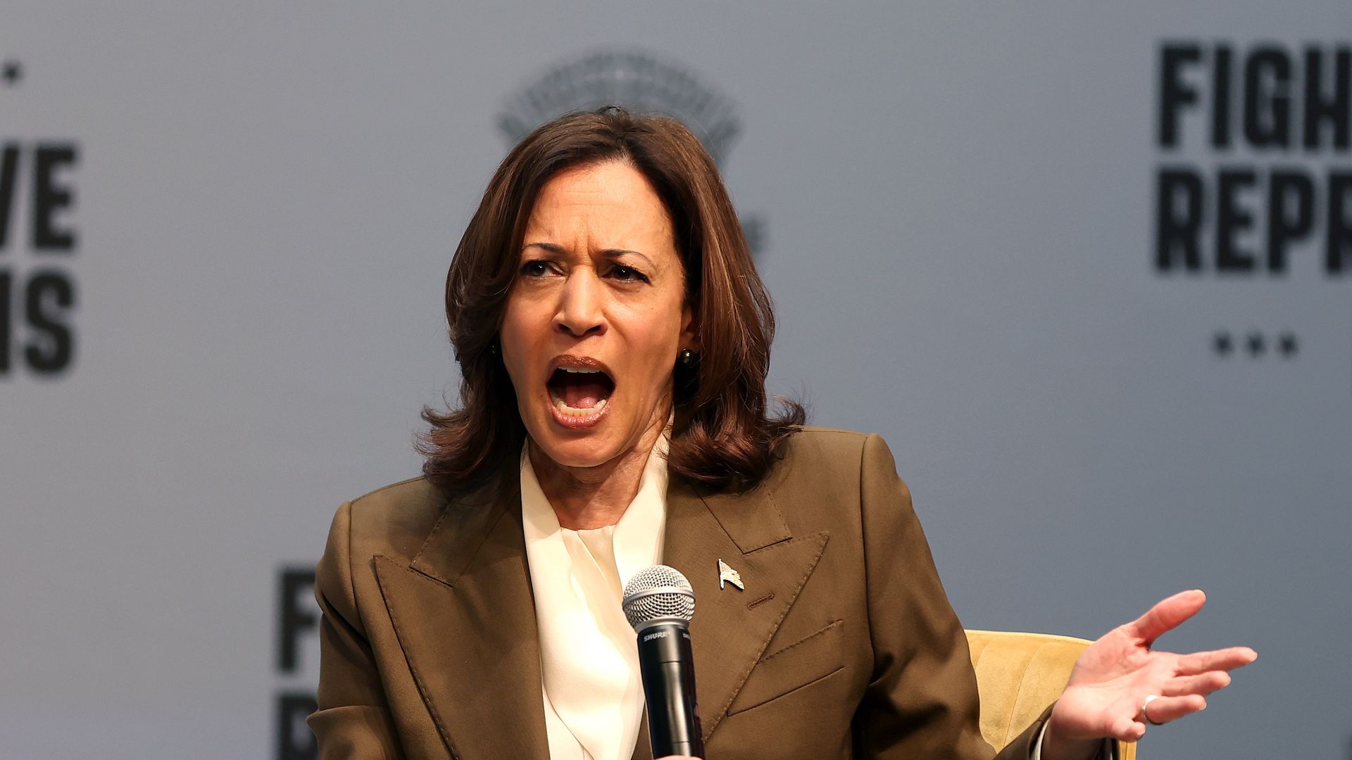 Harris is gesticulating and has her mouth open