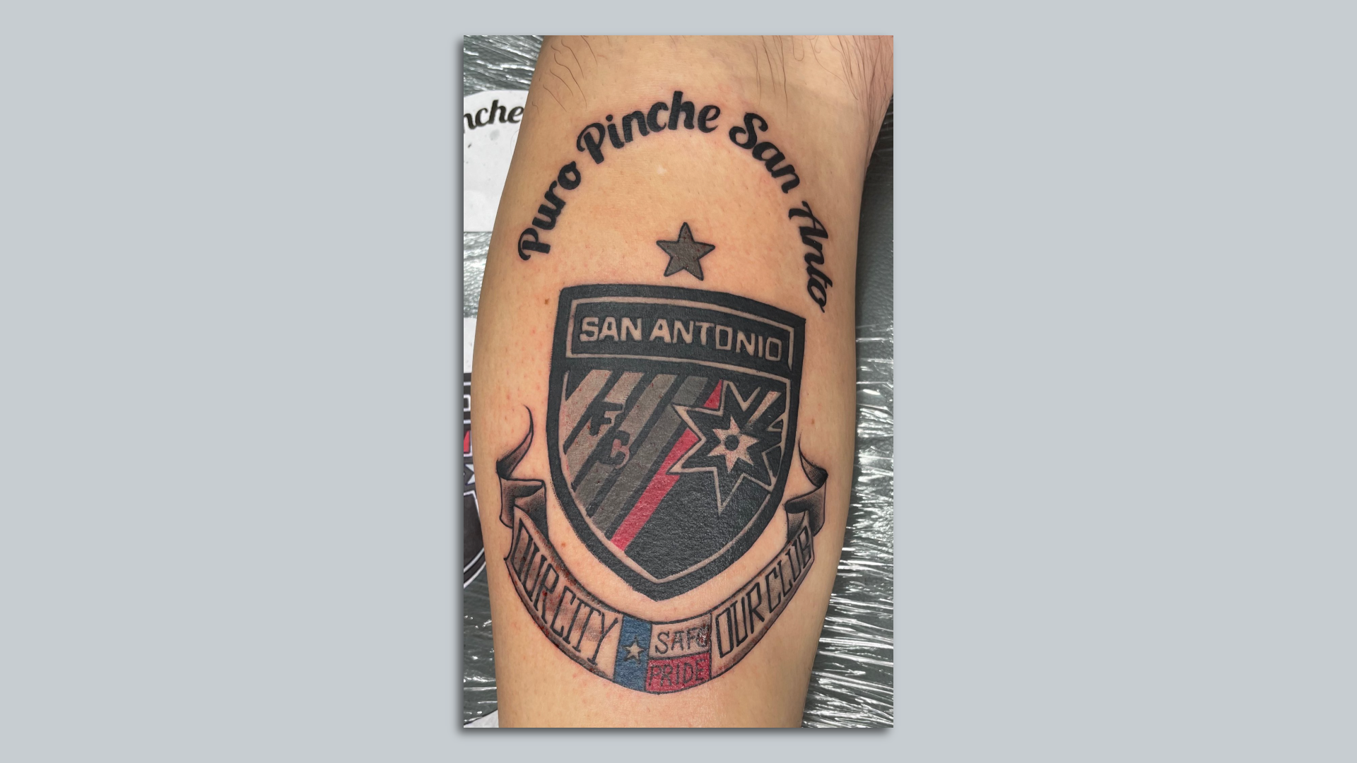 Calf tattoo of the SAFC logo with red and black stripes. 