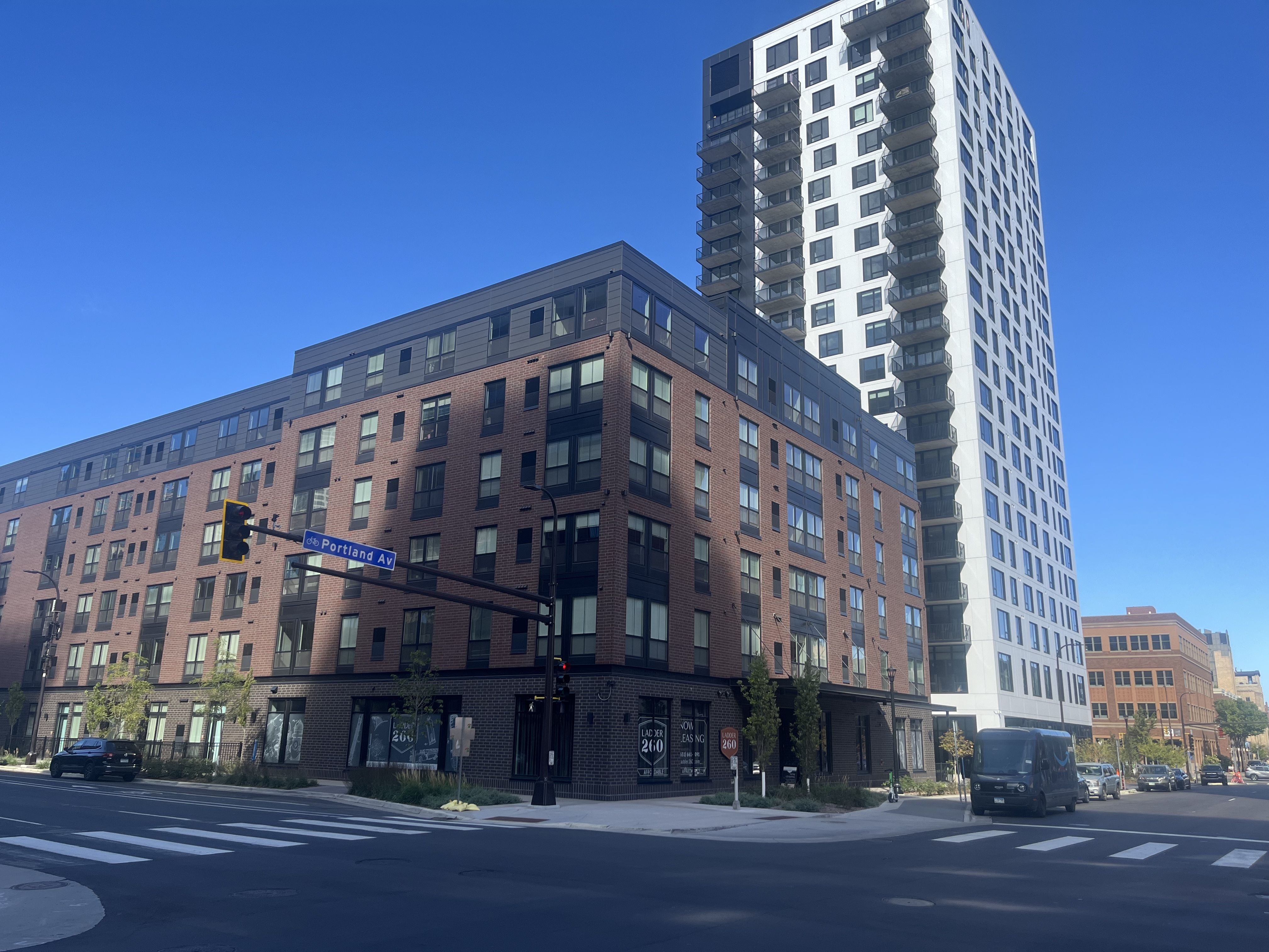 A brick building in front of a tower