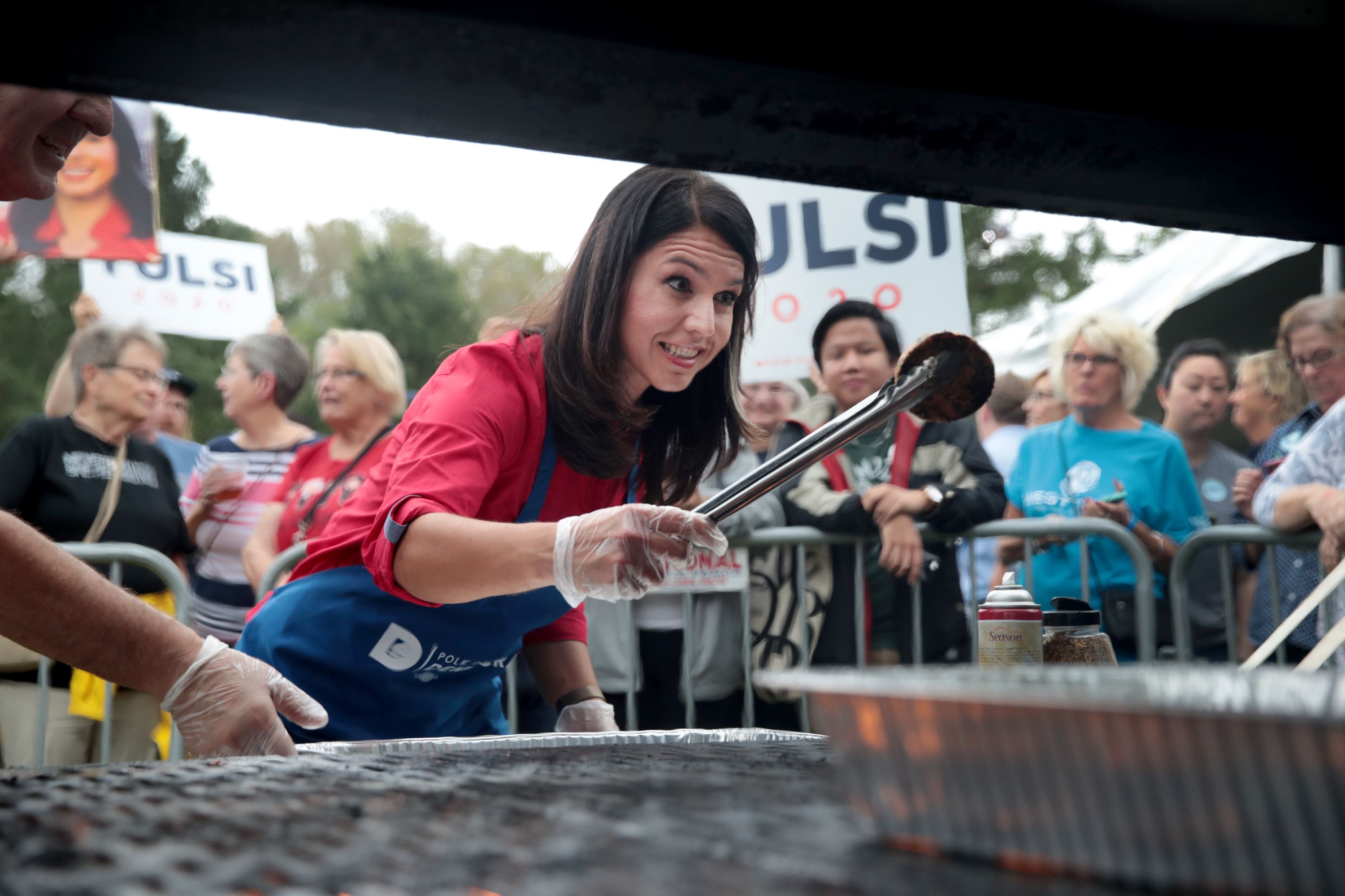 Democratic presidential candidate Rep. Tulsi Gabbard (D-HI) works the grill during a visit to the Polk County Democrats Steak Fry on September 21, 2019 in Des Moines, Iowa. 