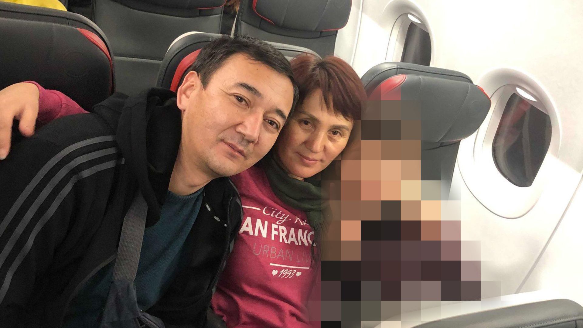 A photo of the Kyrgyz family from Xinjiang on a plane