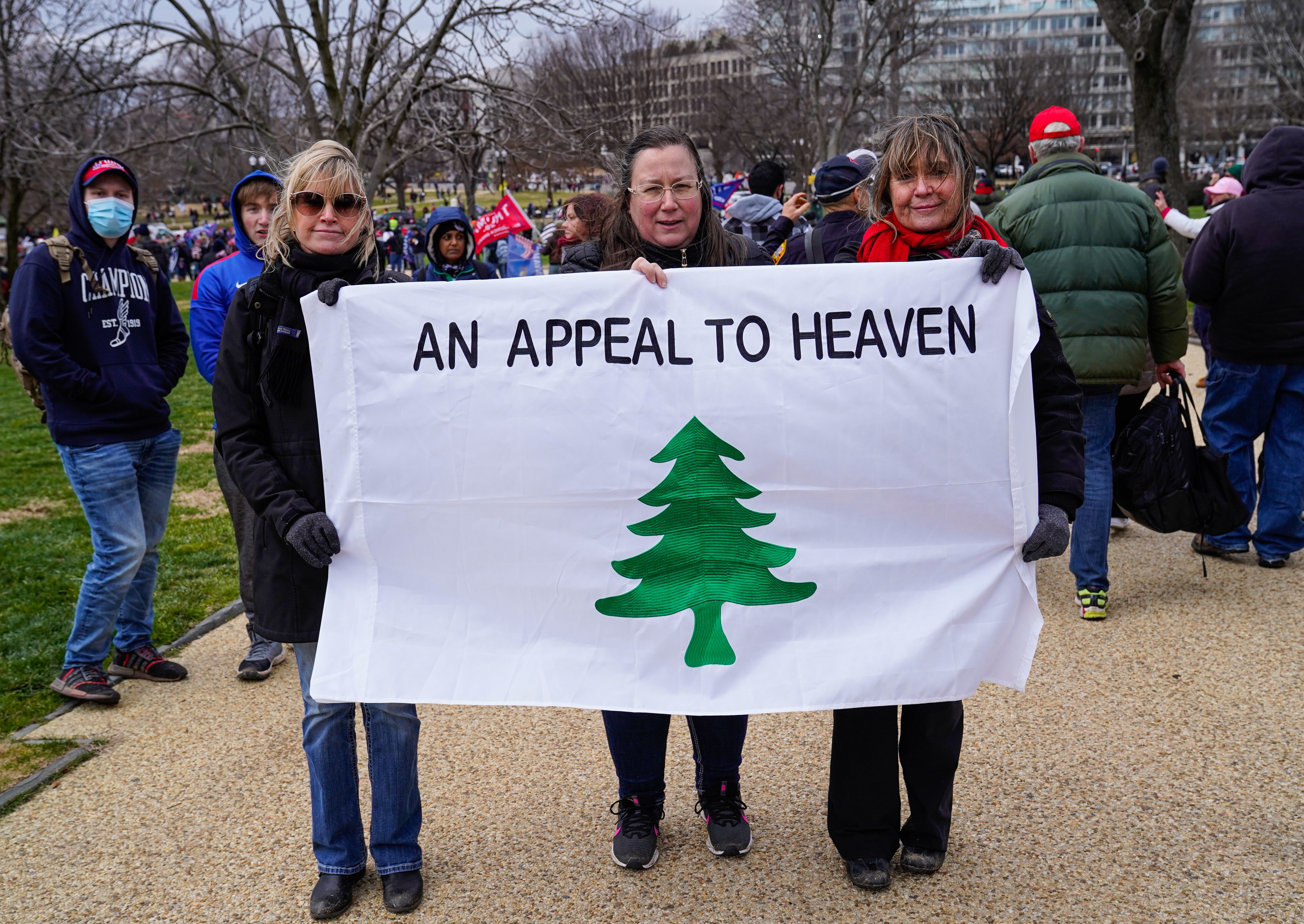 Trump supporters at the Jan. 6 insurrection hold an "Appeal to Heaven" flag, a symbol linked to Christian nationalism.