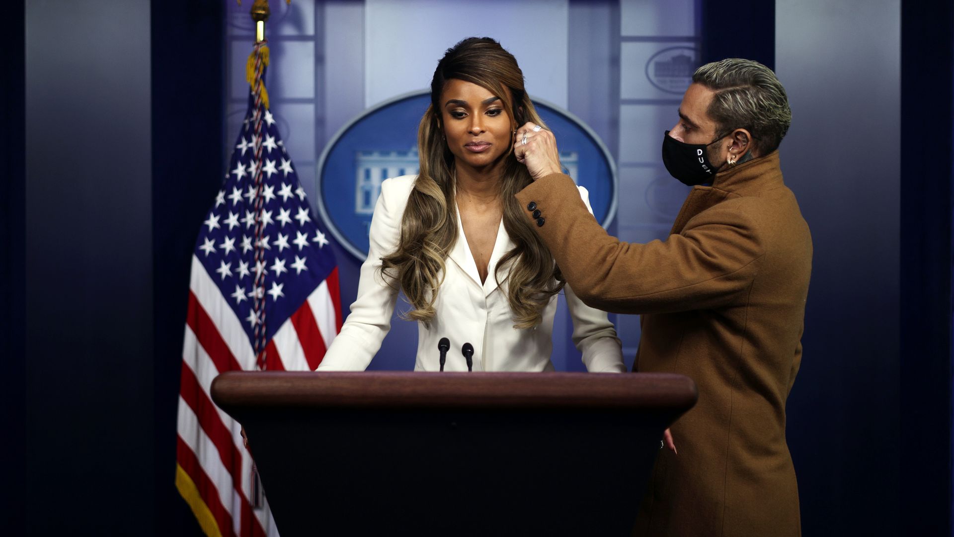 Singer Ciara Wilson is seen having her hair fixed before an appearance in the White House Briefing Room.